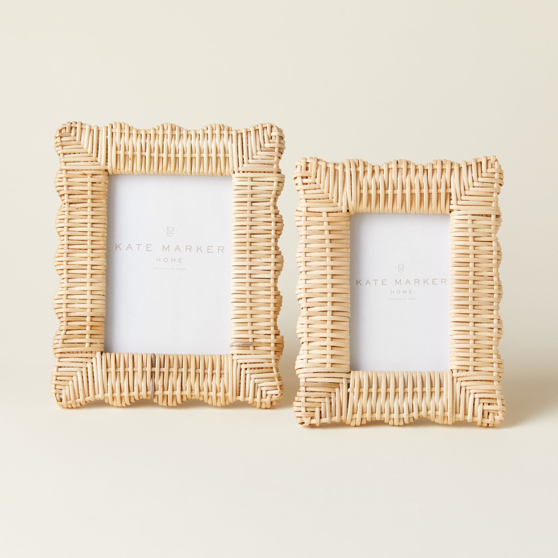 Set of two hand-woven rattan photo frames with a scalloped edge.