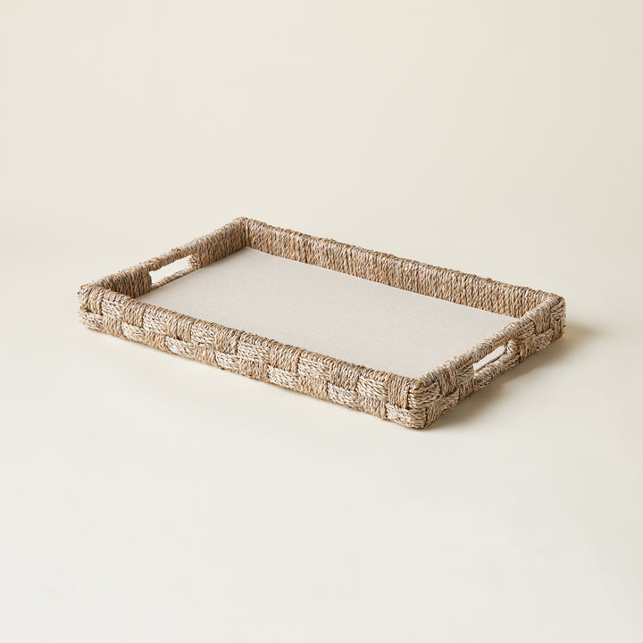 Woven seagrass and rattan serving tray with a natural finish.