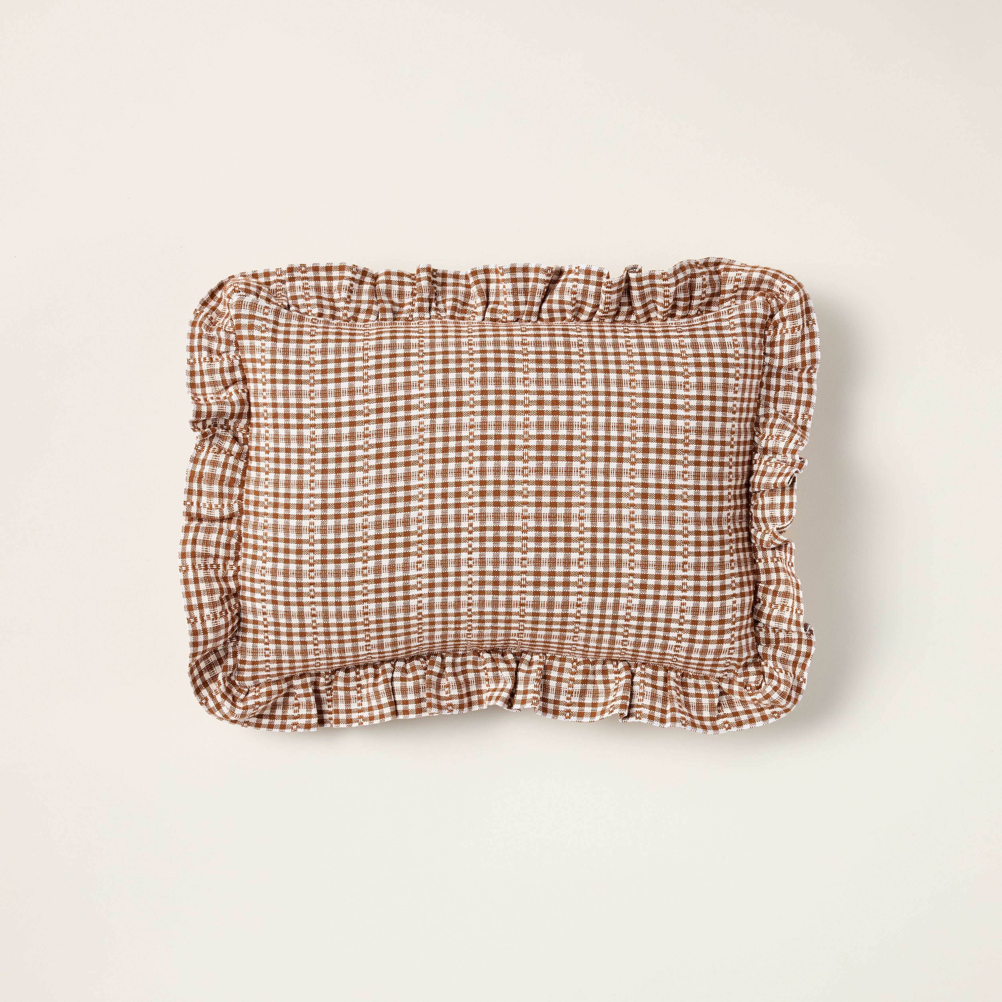 Handwoven Soho Petite throw pillow with a nutmeg brown pattern and a decorative ruffle edge.