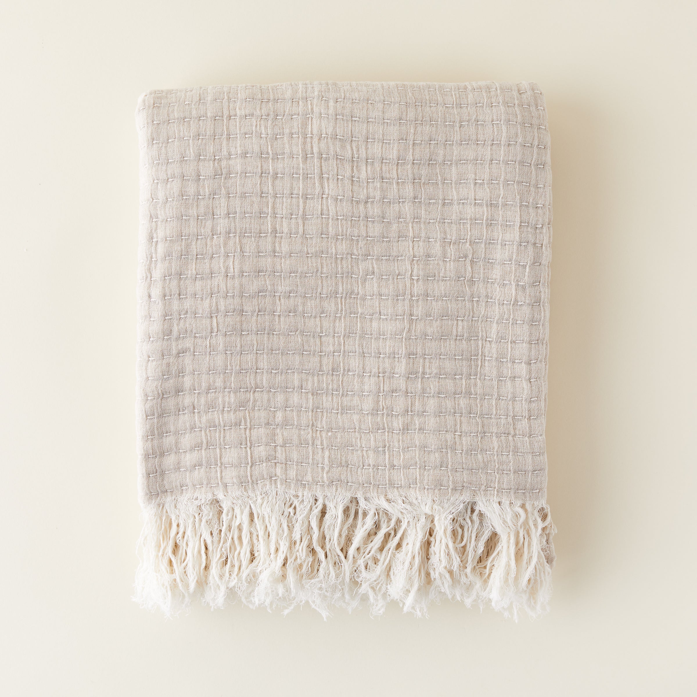 Stitch Throw Blanket for home decor. Soft, luxurious woven throw blanket in a neutral color, styled for a living room sofa or bedroom bedding.