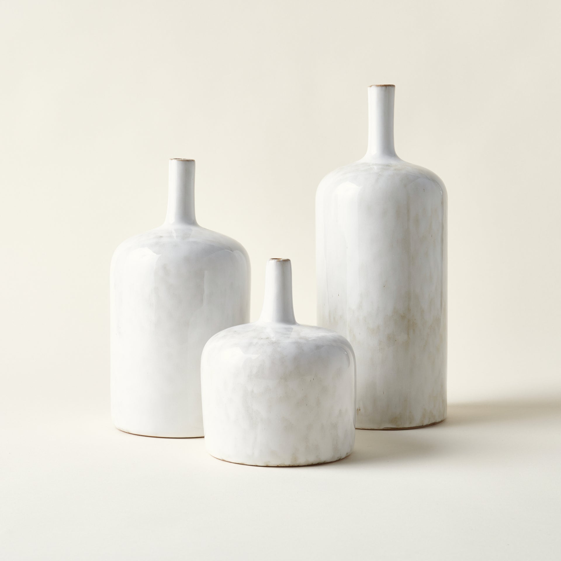 Set of three stoneware vases with bottleneck forms.