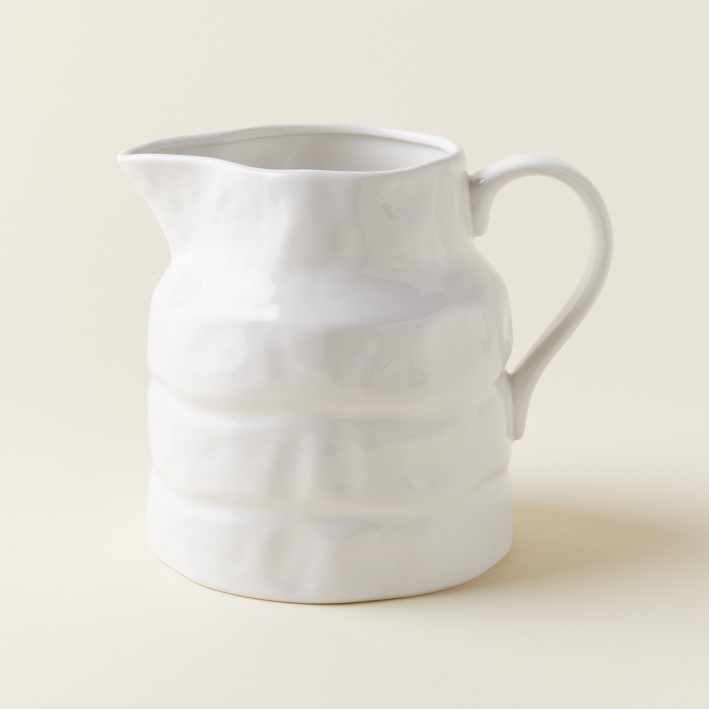 Vintage-inspired ceramic pitcher with a uniquely-shaped spout.