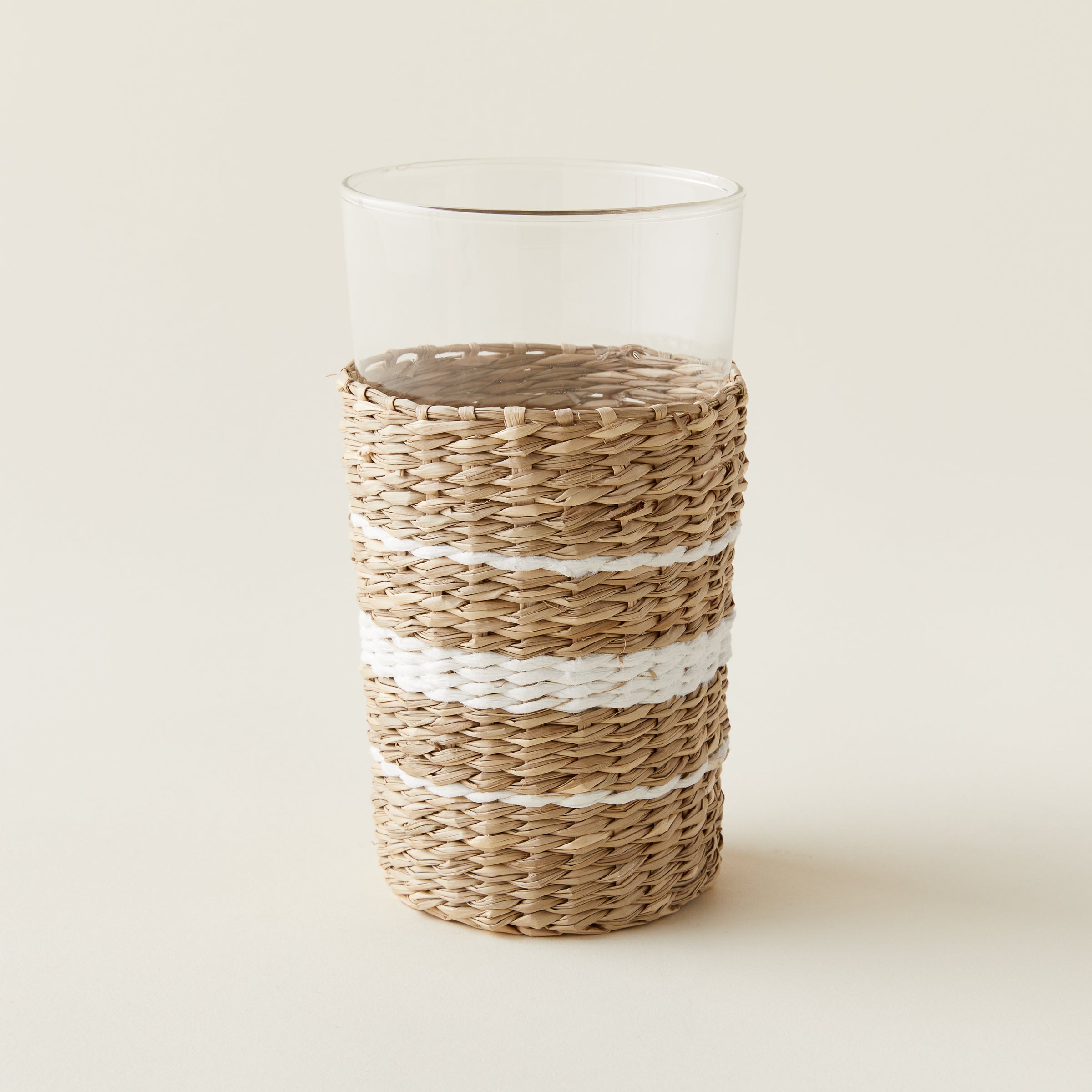 Striped seagrass highball glass with a removable seagrass wrapping.