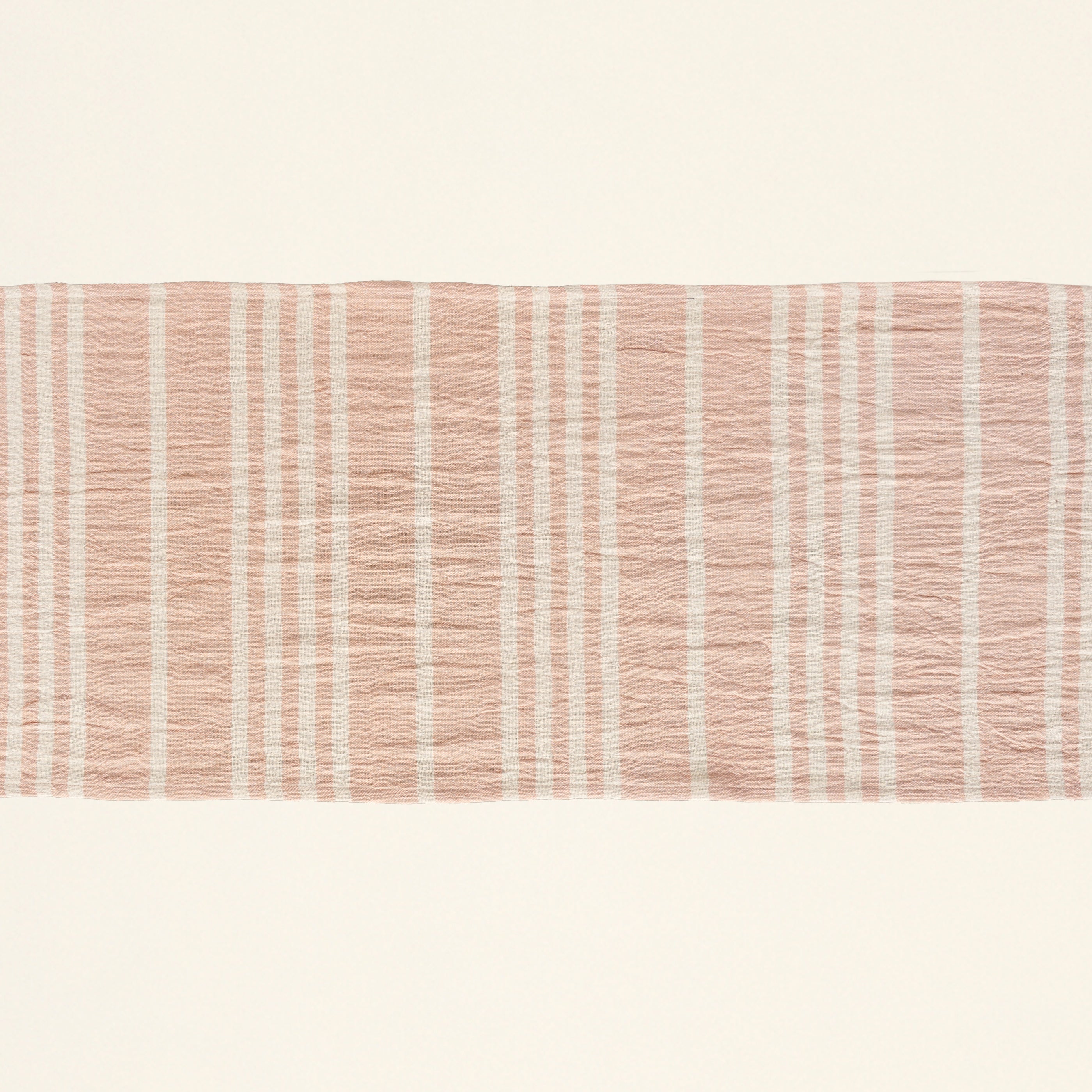 Tilly table runner with alternating pink and cream stripes.