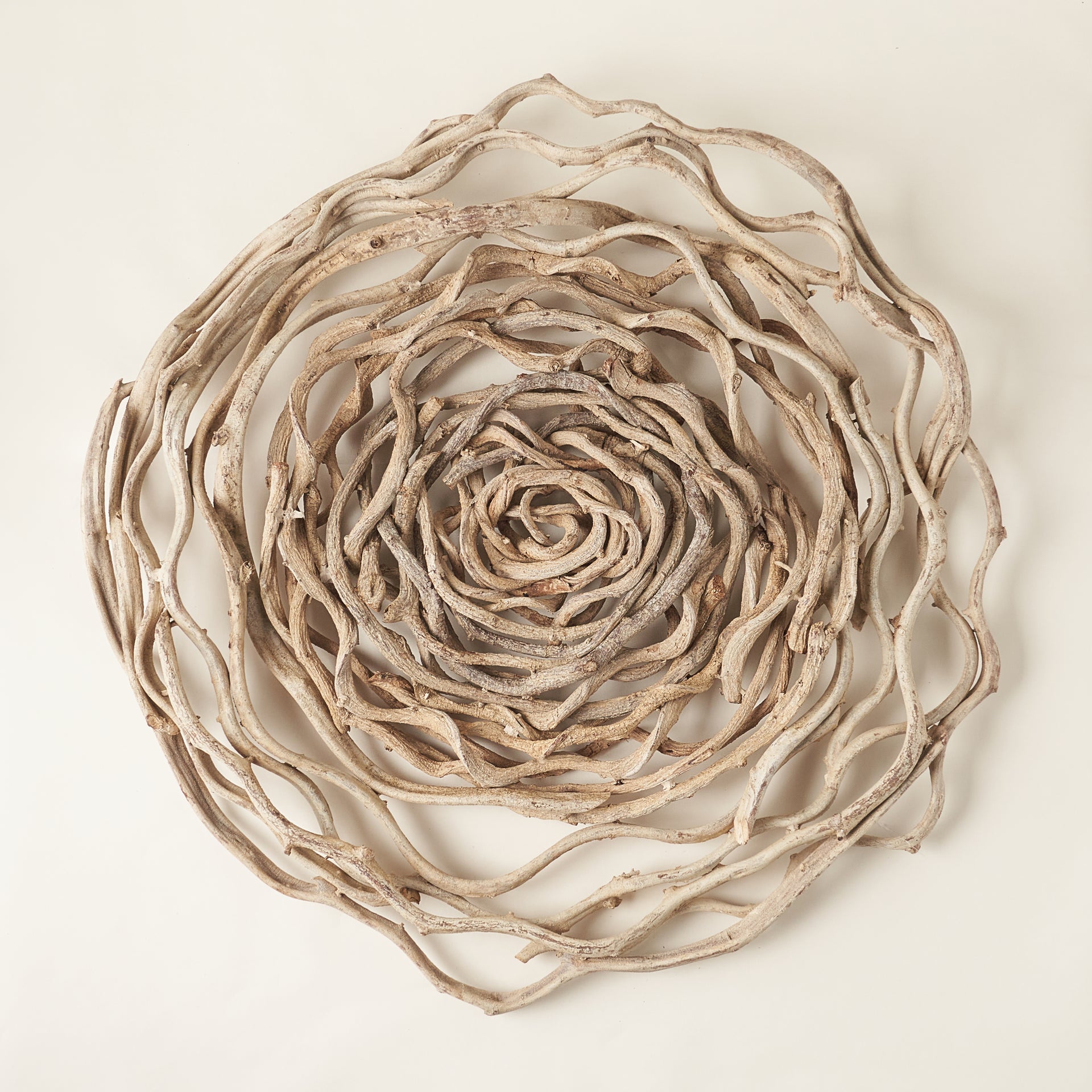 Circle wall art made from a bleached natural vine.