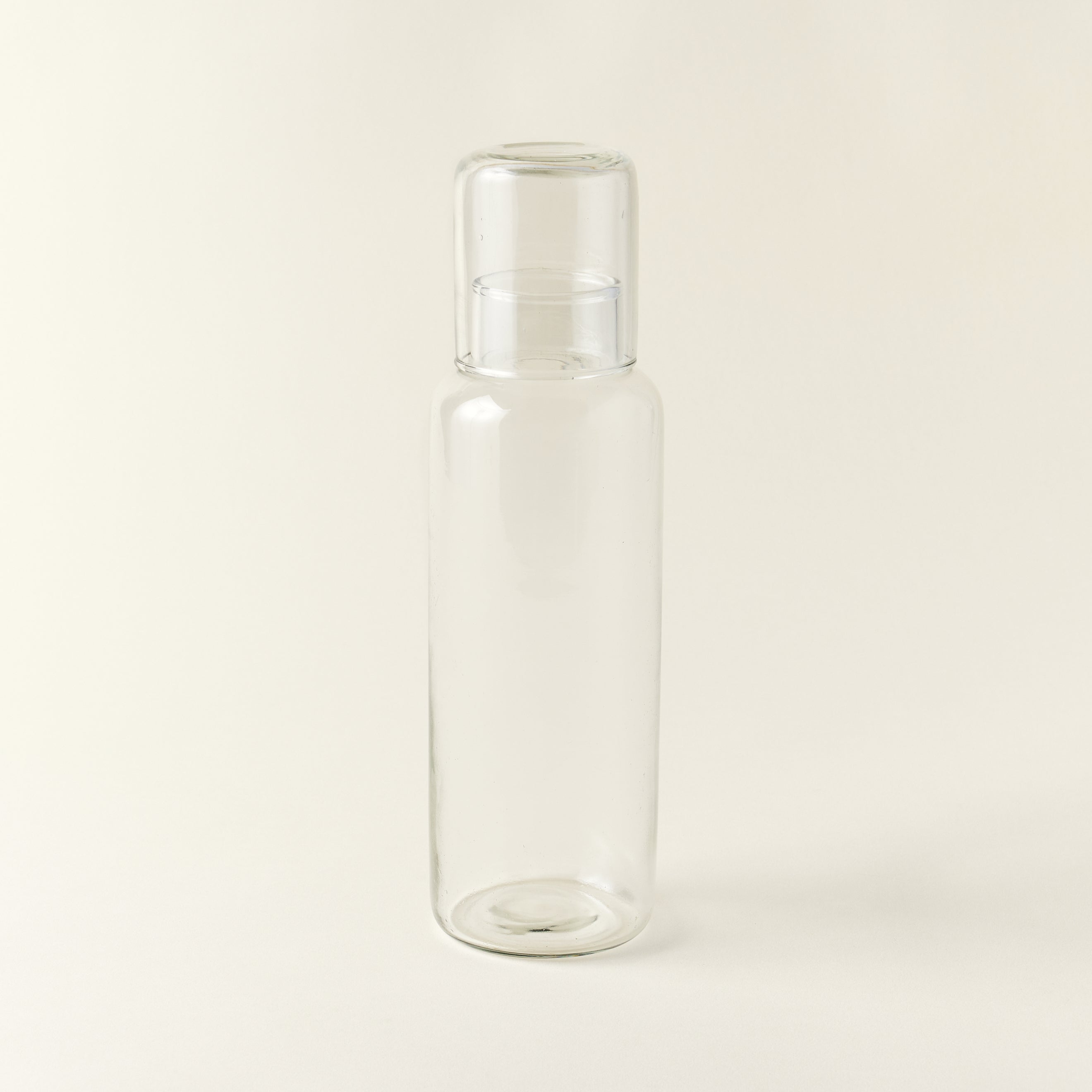 Mouth-blown recycled glass decanter with a matching drinking glass.