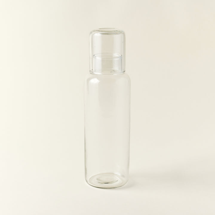 Mouth-blown recycled glass decanter with a matching drinking glass.