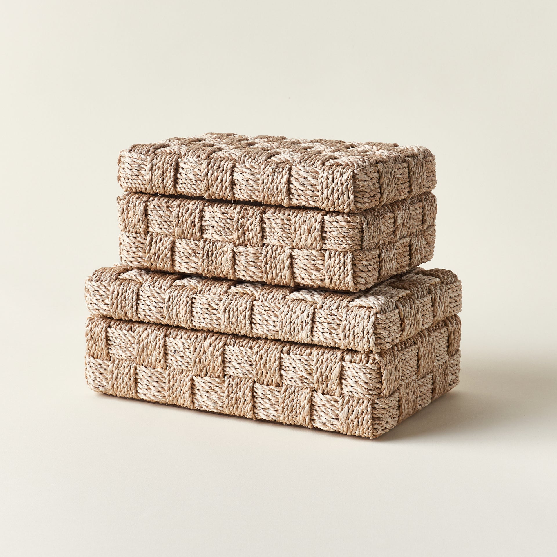 Set of two natural abaca rope hinge boxes in different sizes, with suede interiors.