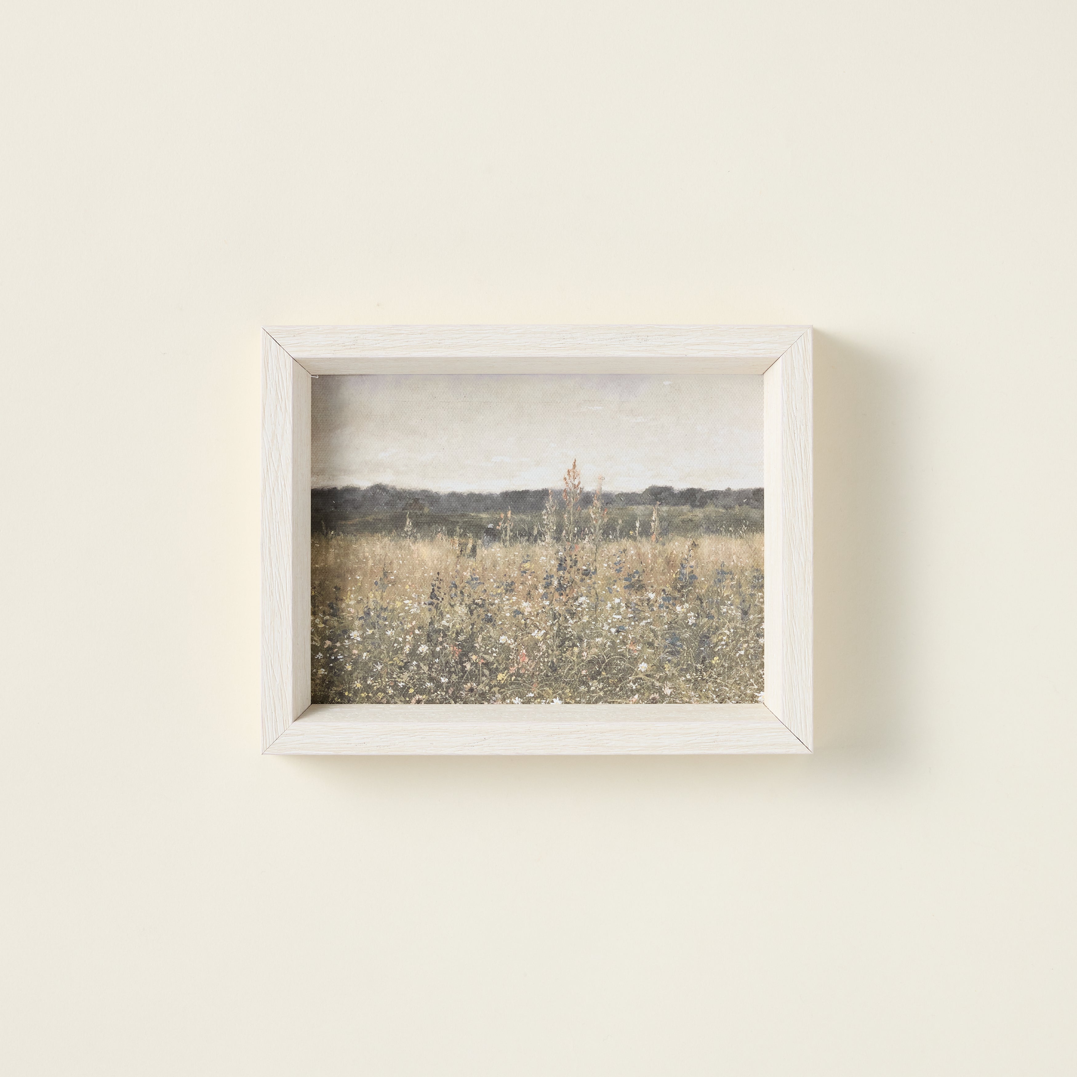 Framed art print of a wildflower field on raw canvas with an antique-style frame.