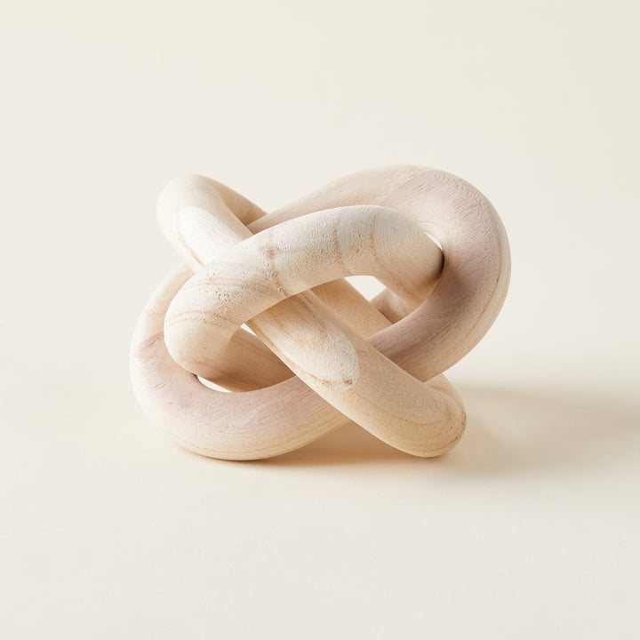 A decorative chain of interlocking wooden links carved from rustic pine.