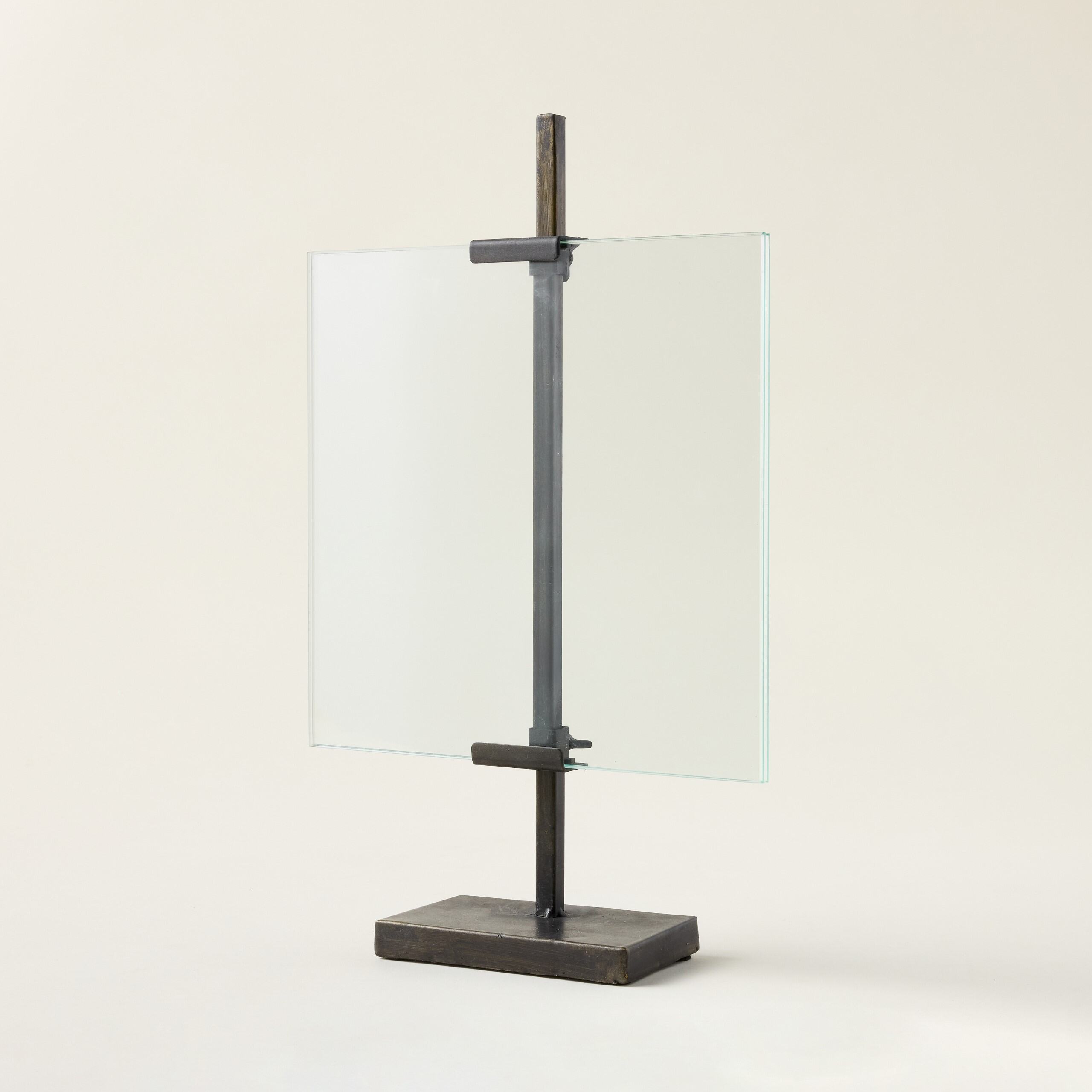 A floating photo frame with a black metal stand.
