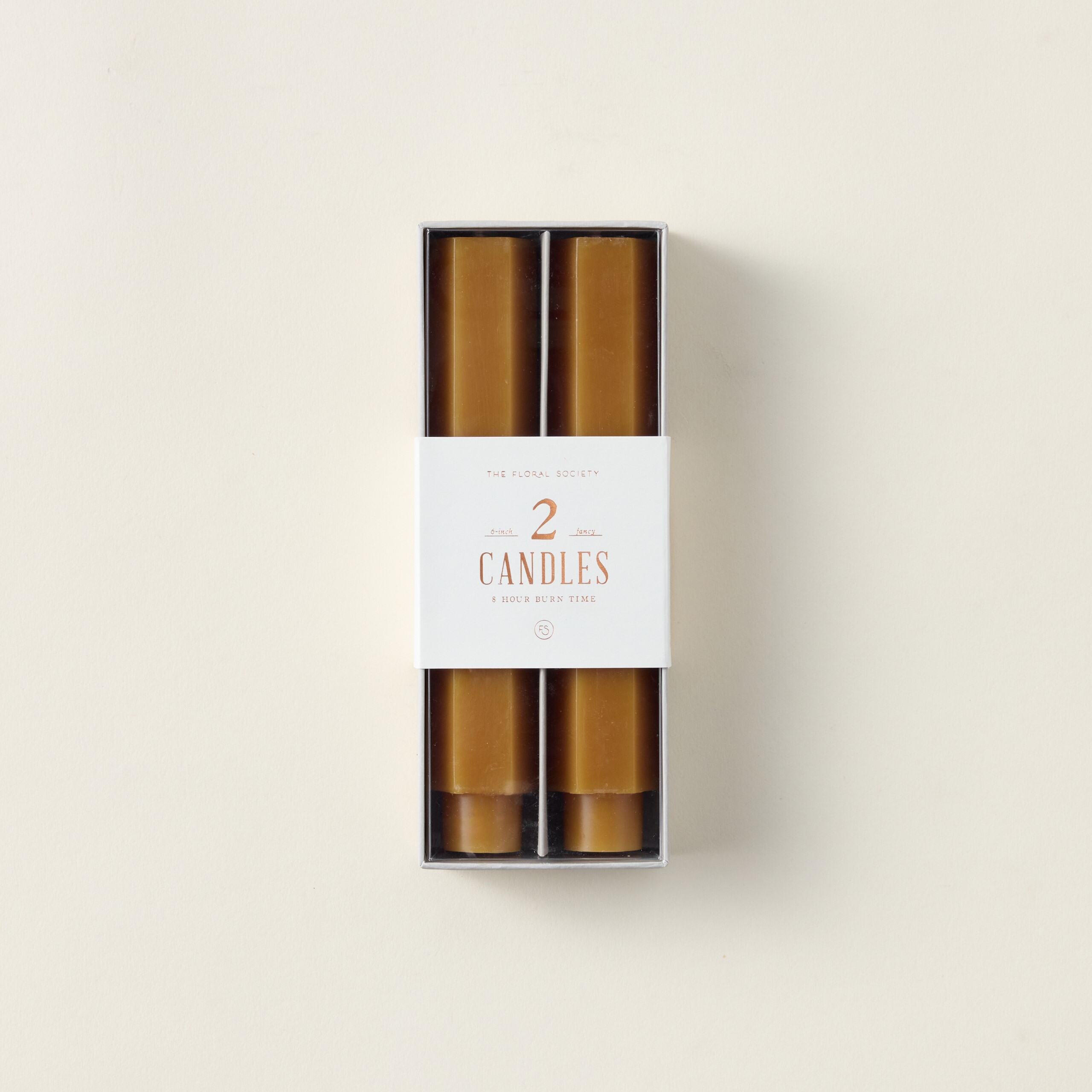 Hexagon-shaped taper candles in a subtle color.
