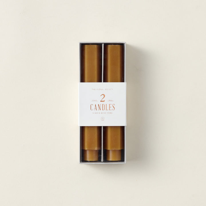 Hexagon-shaped taper candles in a subtle color.