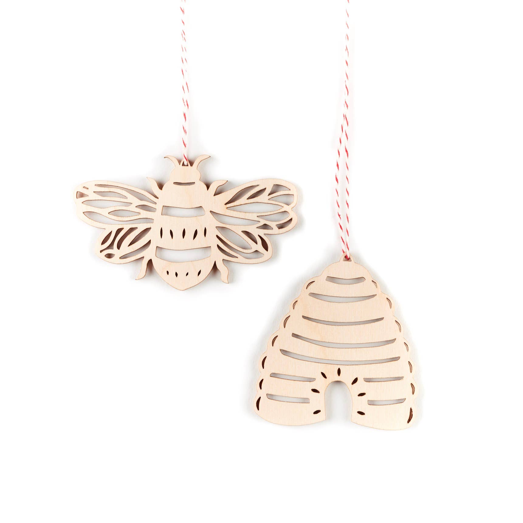 A set of wooden ornaments shaped like bees and beehives.