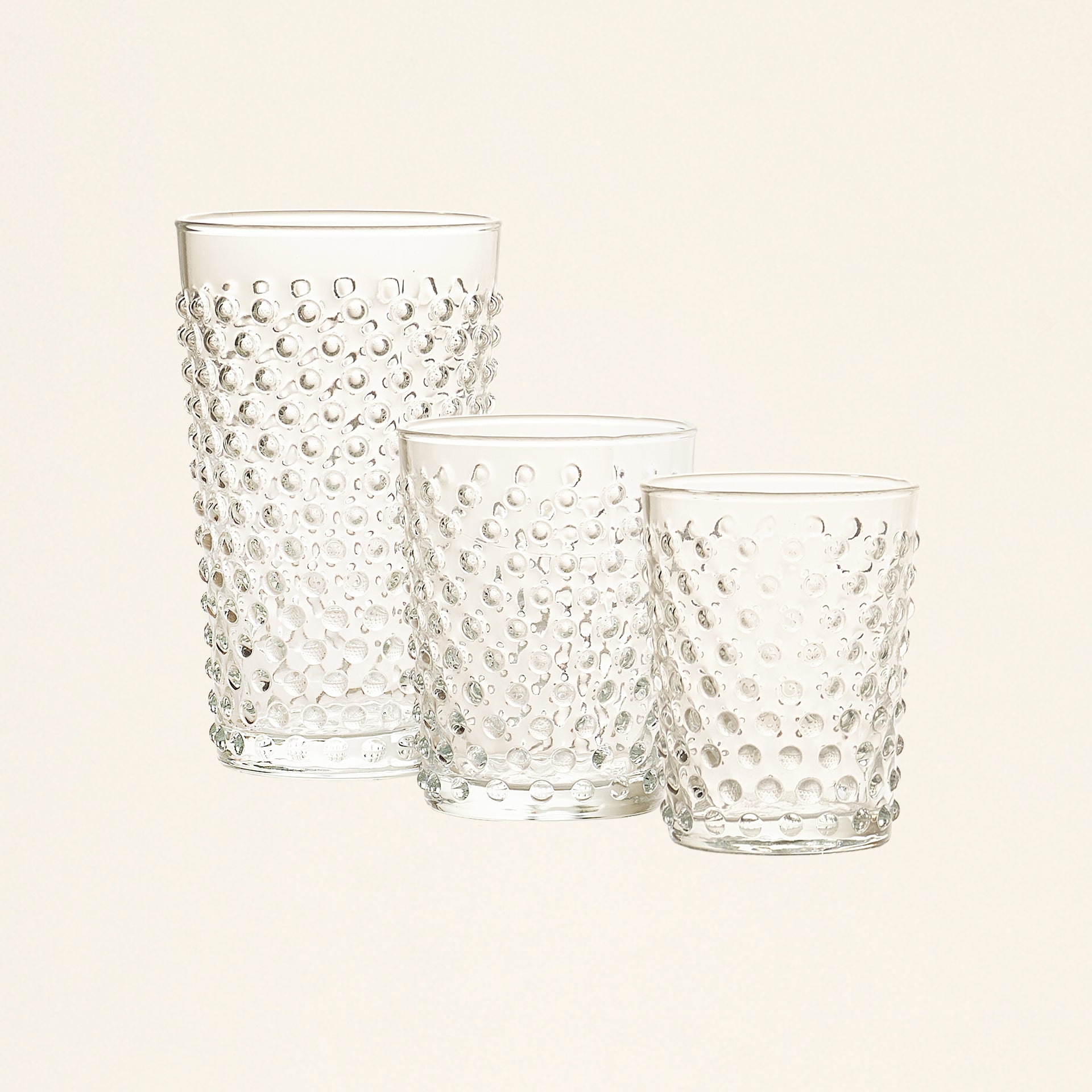 Set of three clear glasses with a raised dot pattern in varying sizes.