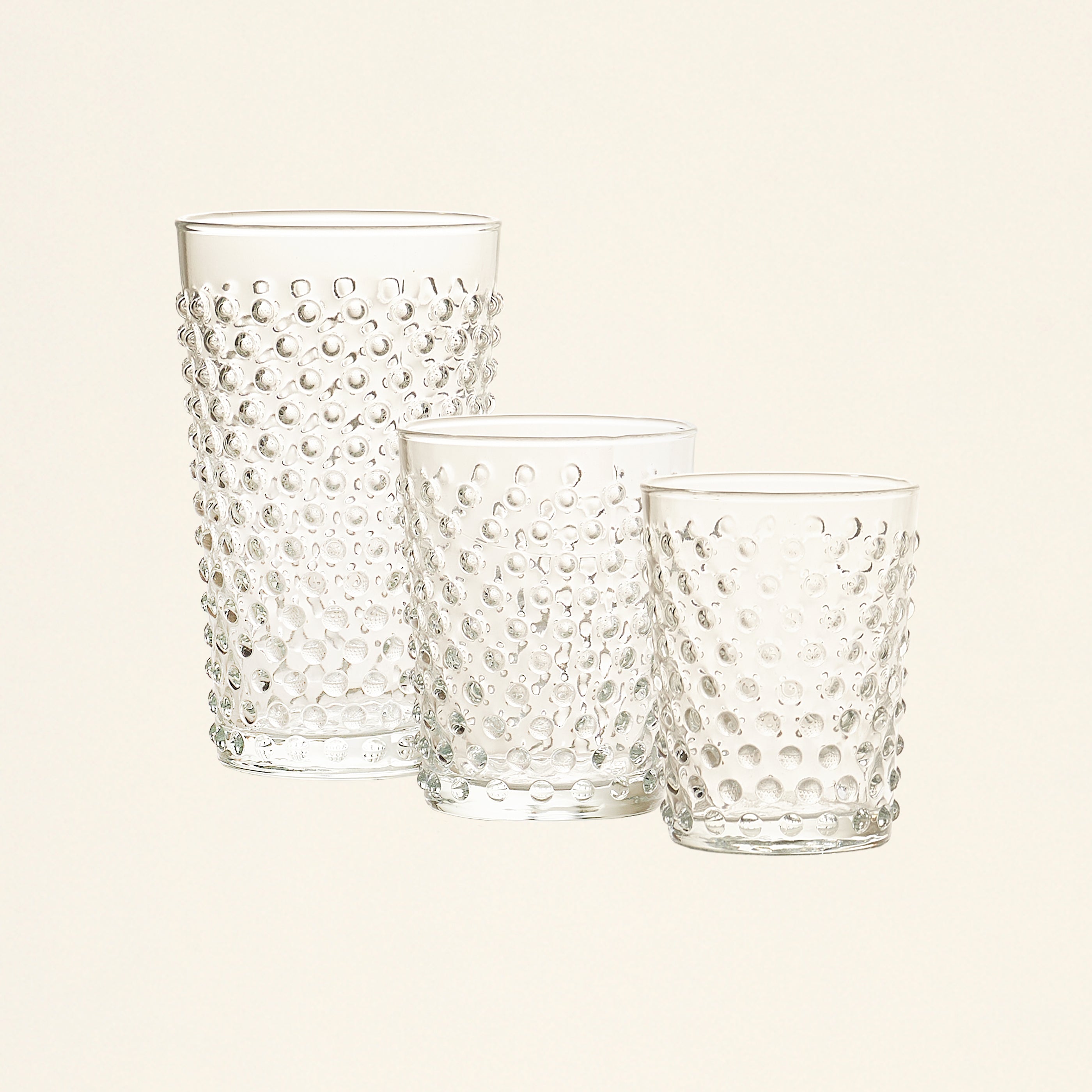 Set of three clear glasses with a raised dot pattern in varying sizes.