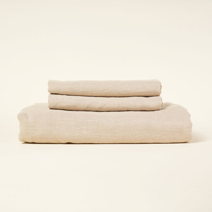 A European linen duvet cover set in a natural color with two pillowcases.