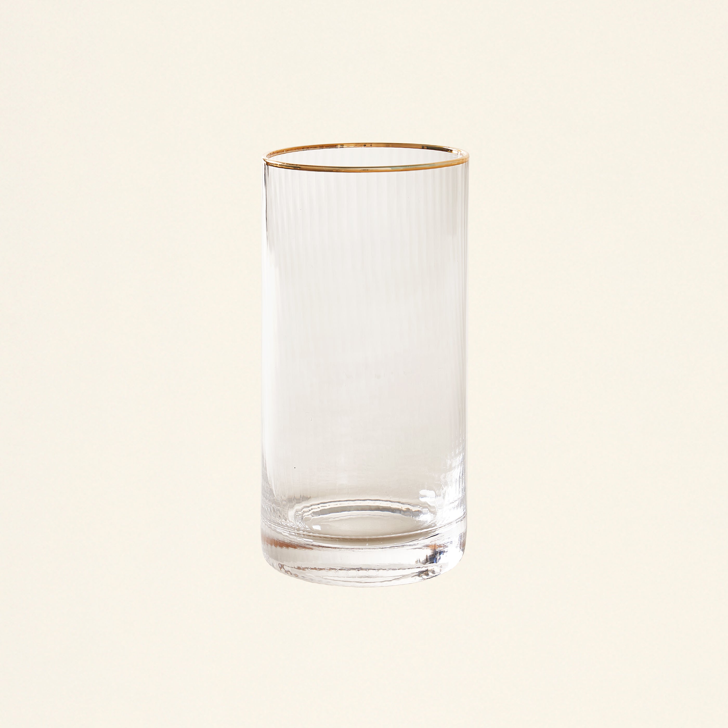 Clear highball glass with a vertical optic pattern and a hand-painted gold rim.