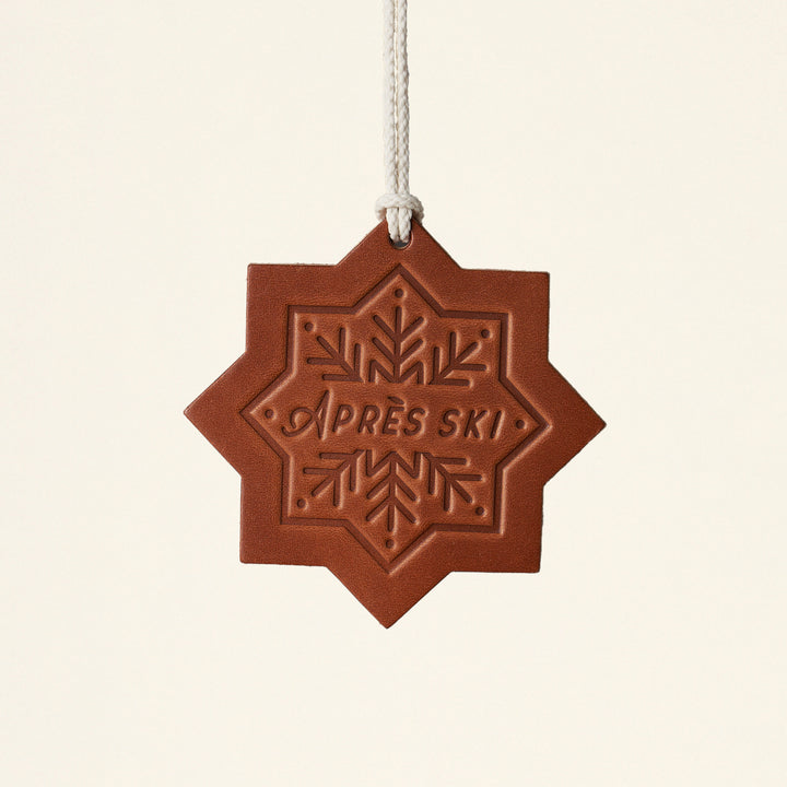 A handcrafted leather Christmas ornament.