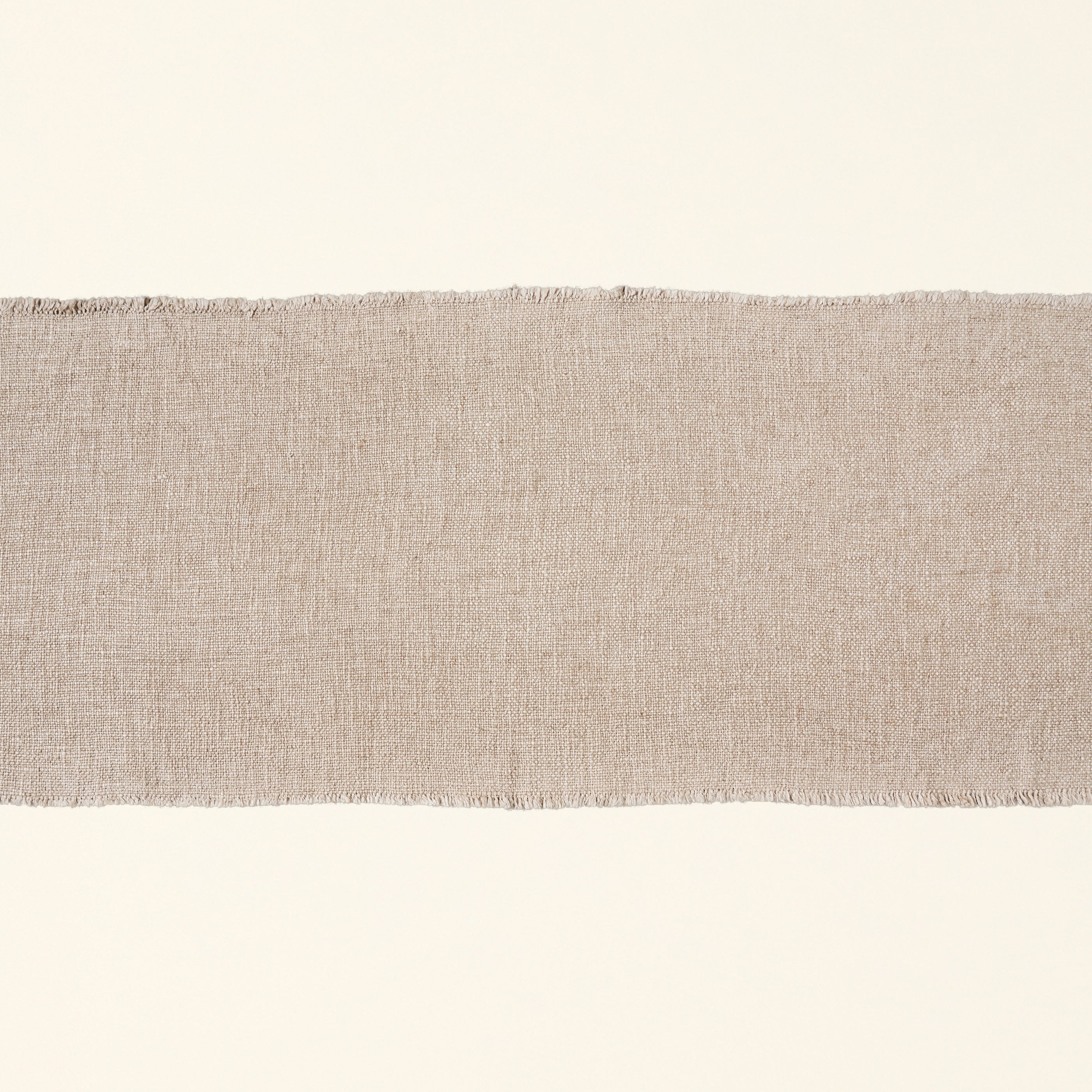 Linen blend table runner with frayed edges.
