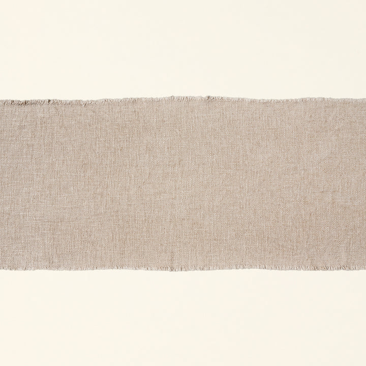 Linen blend table runner with frayed edges.