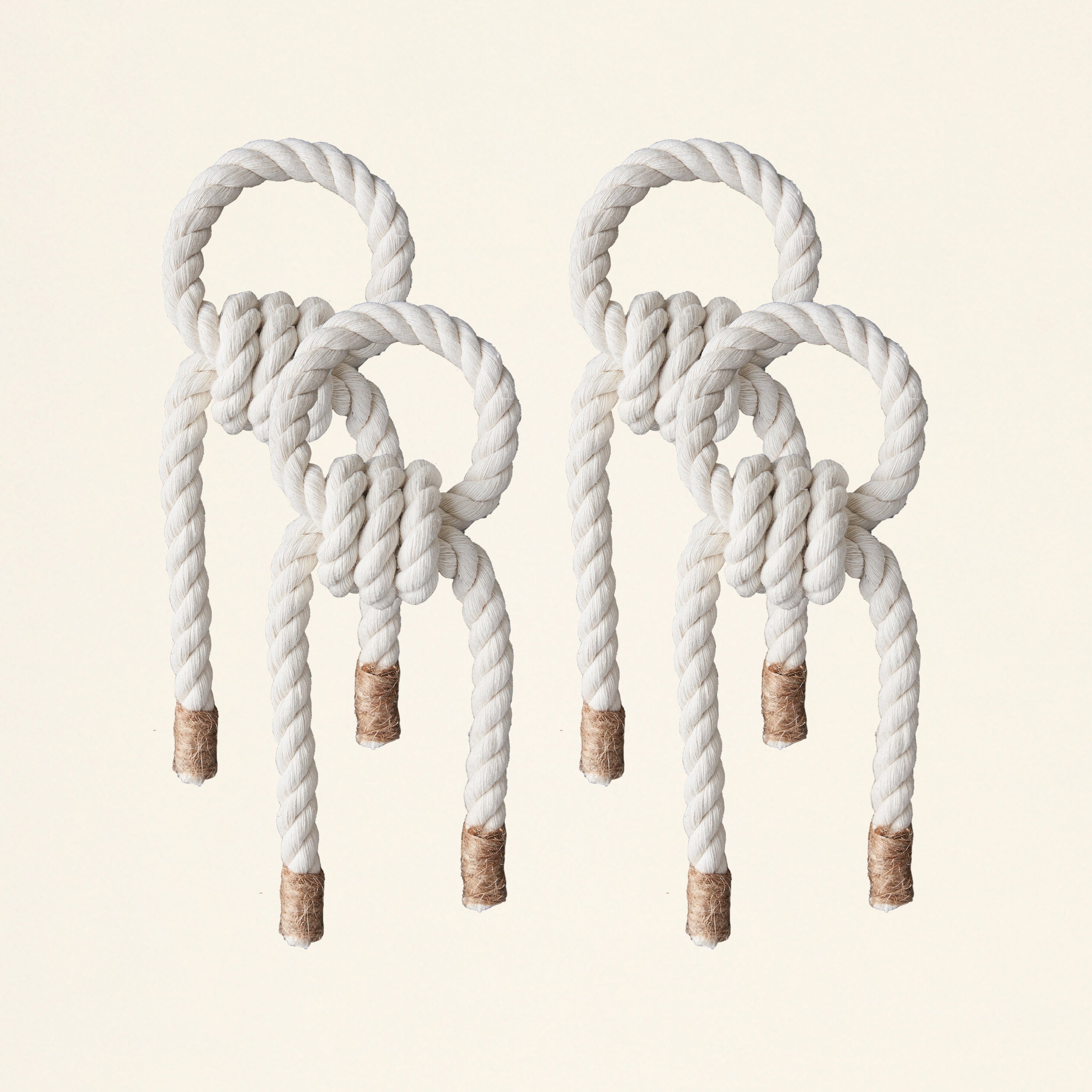 A handmade macramé napkin holder in macramé color and jute.