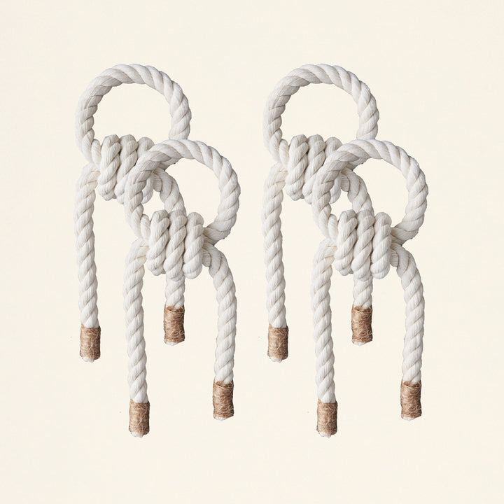 A handmade macramé napkin holder in macramé color and jute.