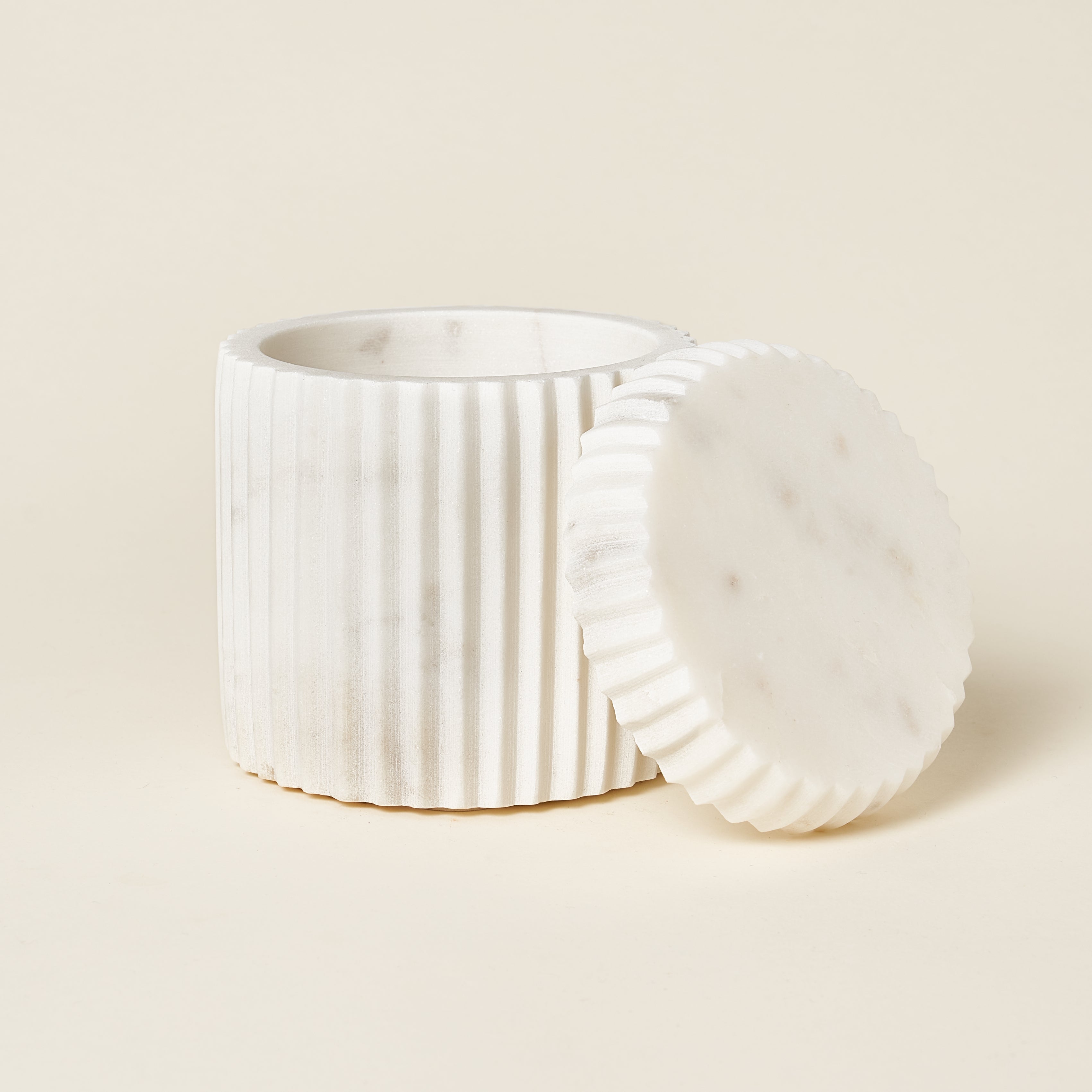 White marble fluted canister with a matching lid.