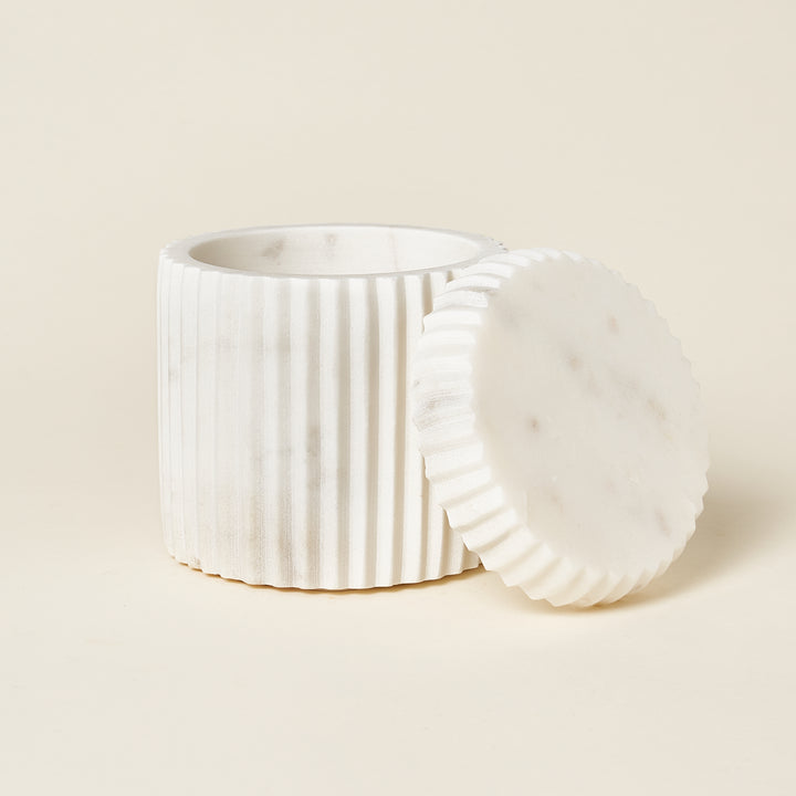 White marble fluted canister with a matching lid.