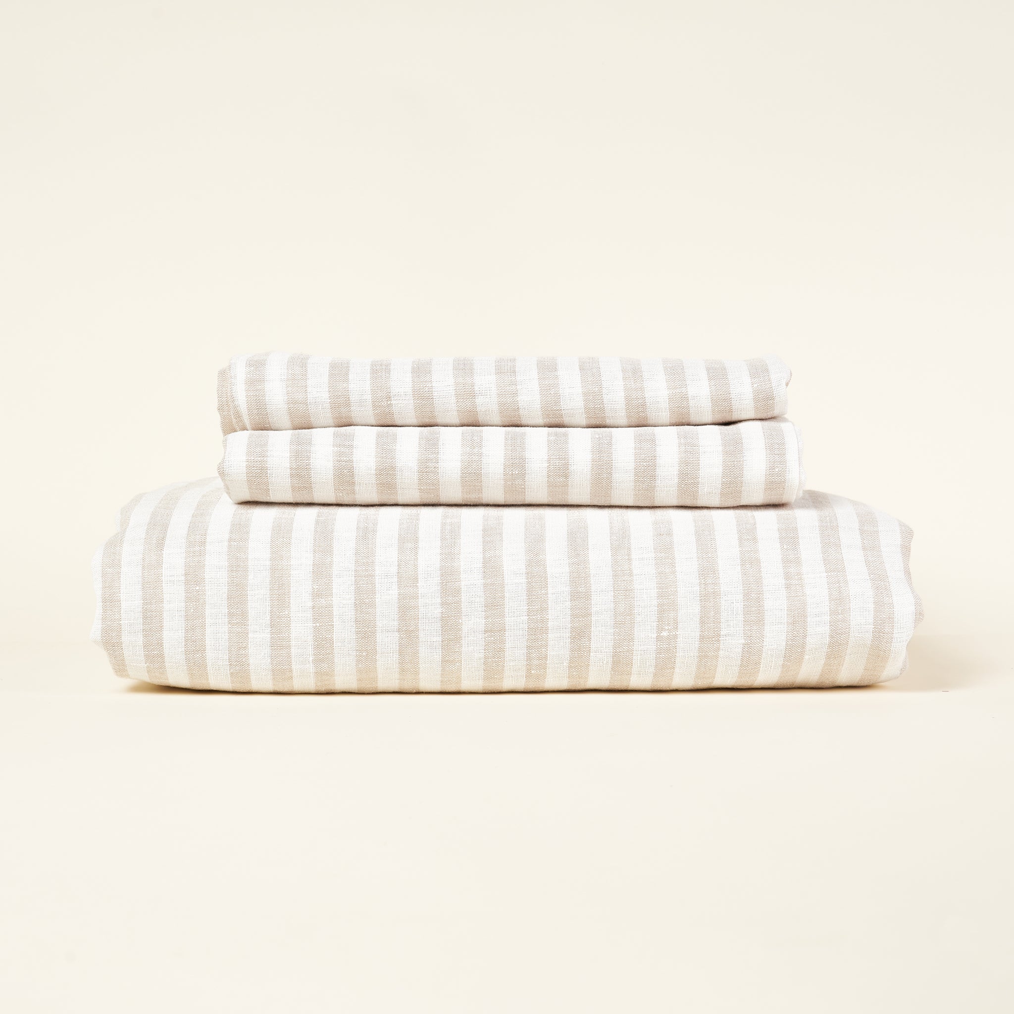 A striped European linen duvet cover set in a natural color with two pillowcases.