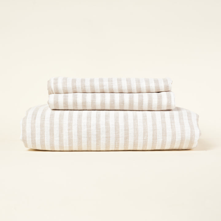 A striped European linen duvet cover set in a natural color with two pillowcases.