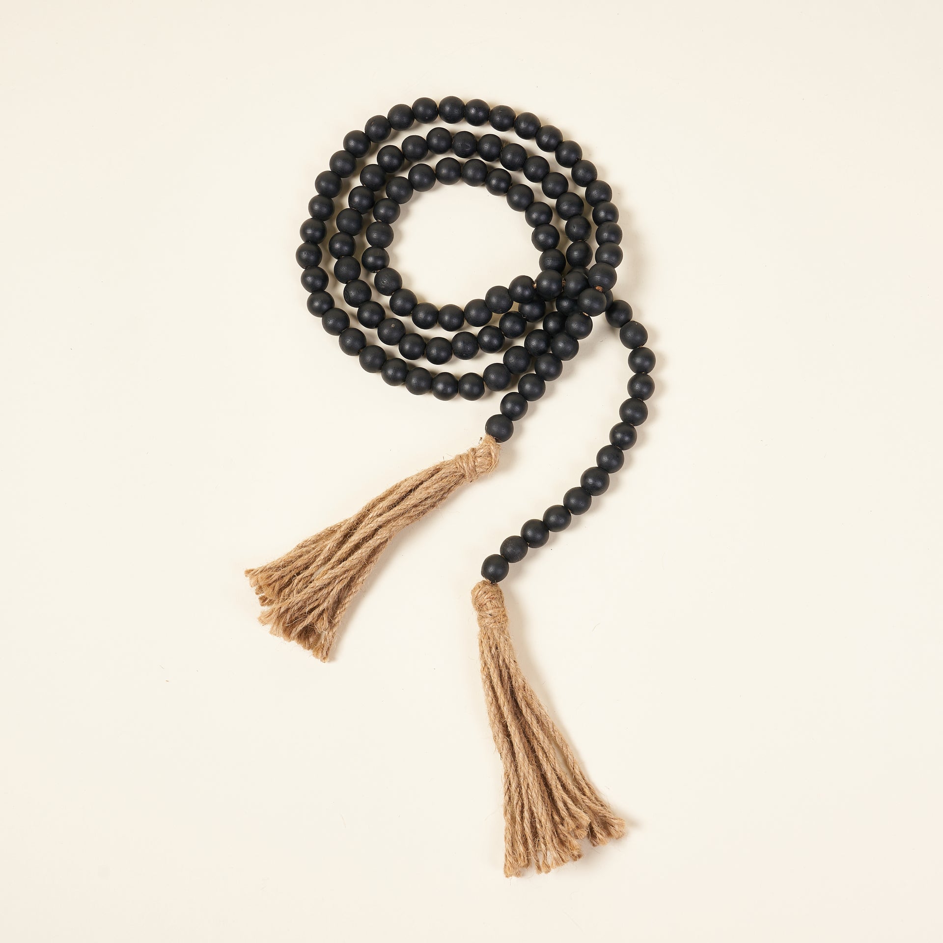 72-inch Paulownia wood bead garland with jute tassels.