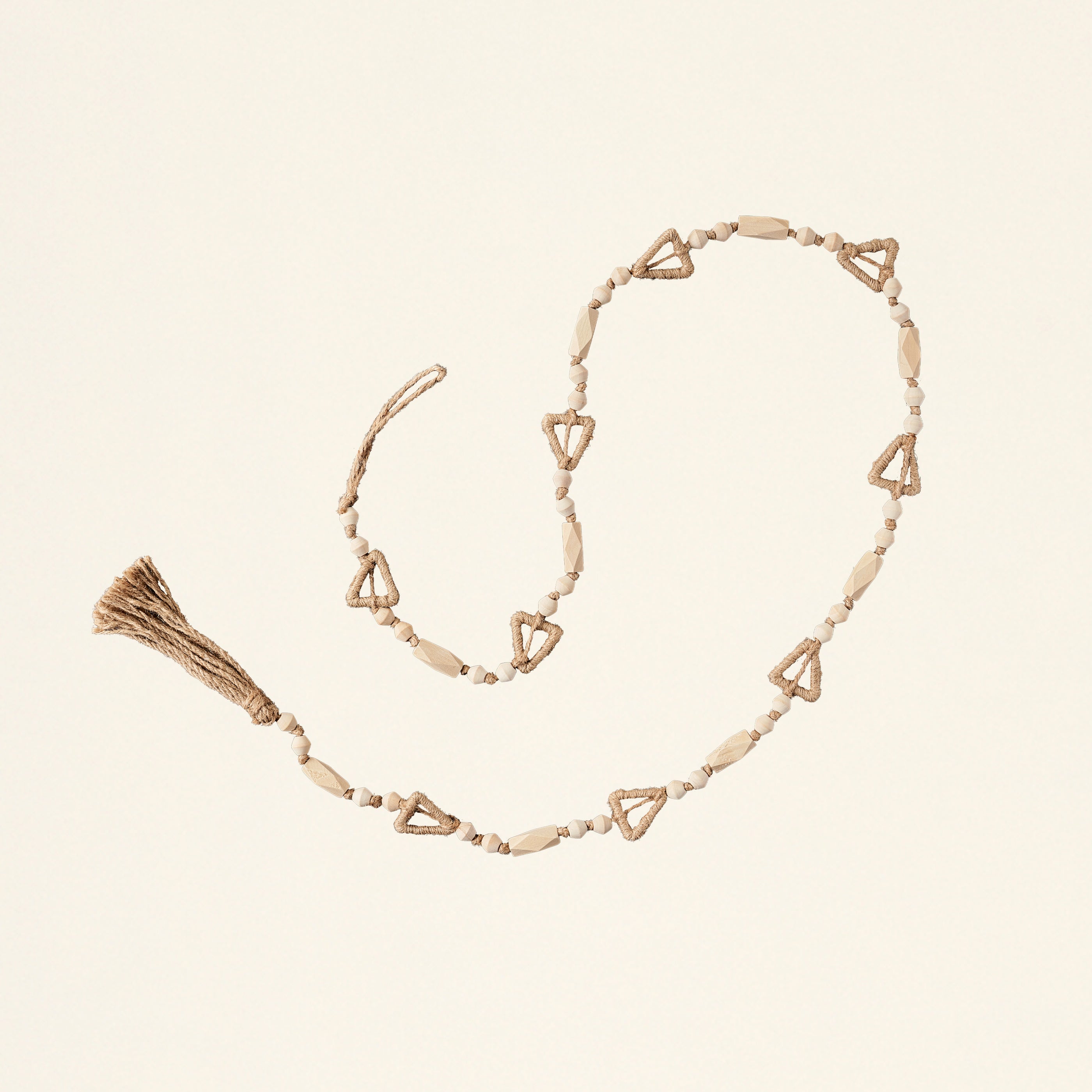 A long garland with various tree-shaped paulownia wood beads and a jute tassel.