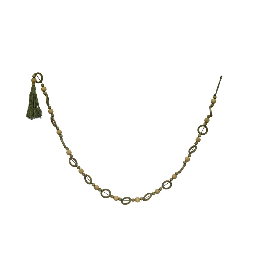 A long garland made of paulownia wood beads, with a green tassel at the end.