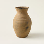 Handcrafted Avery vase with a natural texture and flared opening in a distressed taupe finish.