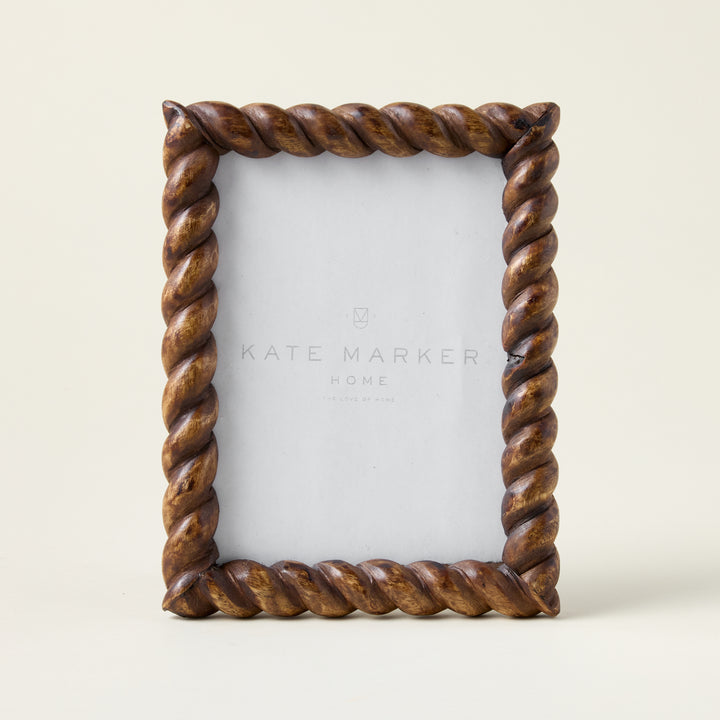 Hand-carved mango wood photo frame with intricate twist detailing and a dark, refined finish.