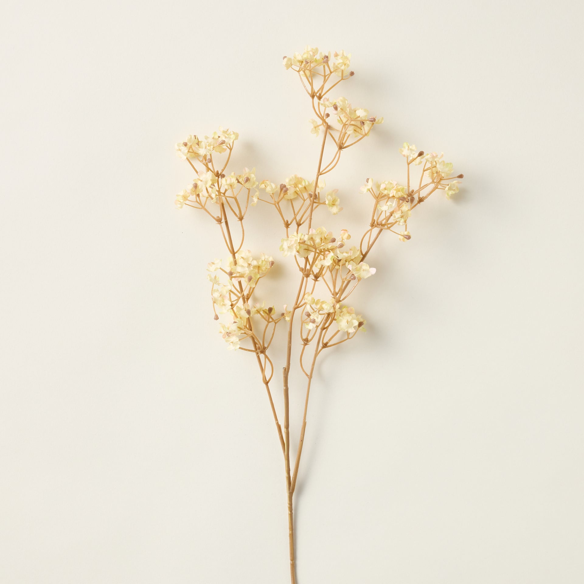 Faux Gypsophila stem with delicate cream clusters for a soft, cloud-like floral arrangement.