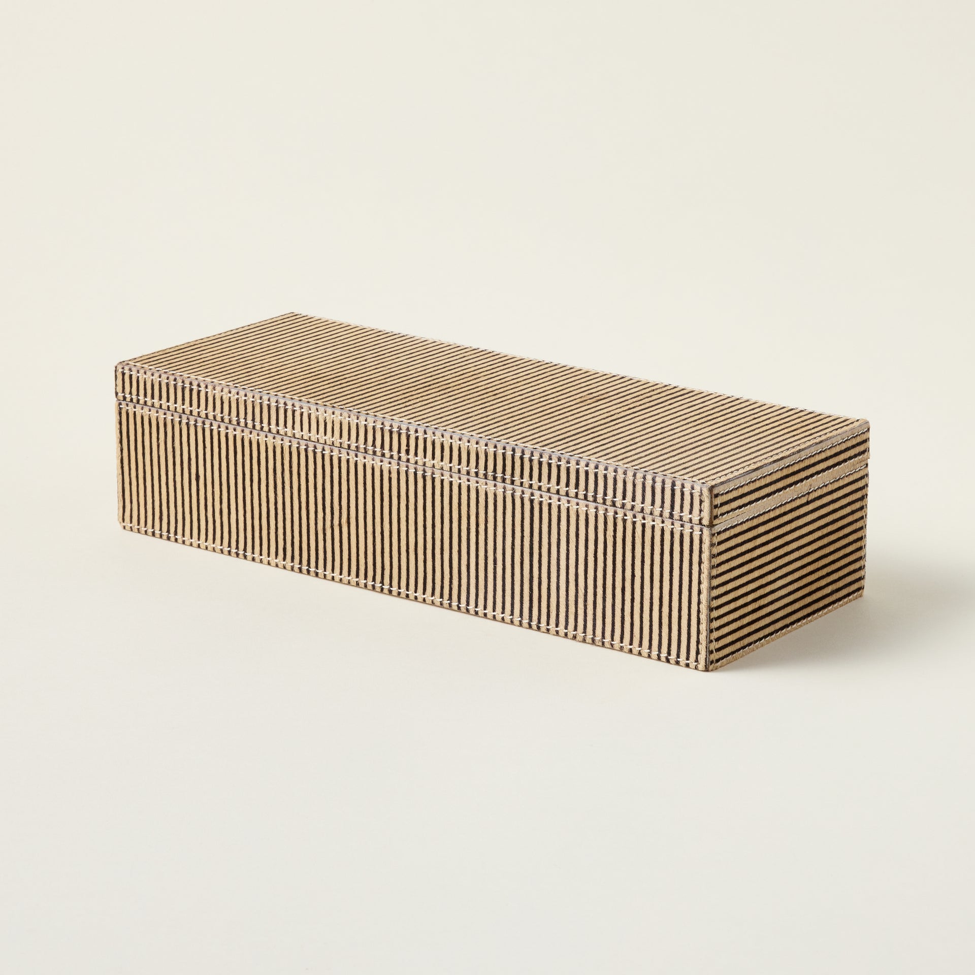 Handcrafted leather box made from genuine hair-on-hide material for decorative storage.