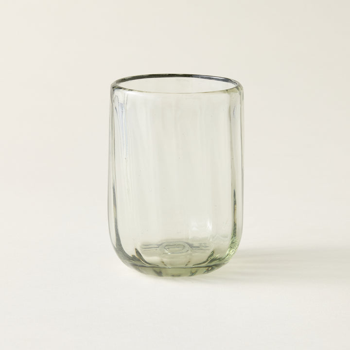 Handblown fluted tumbler crafted from recycled glass with air bubbles and an artisanal feel.