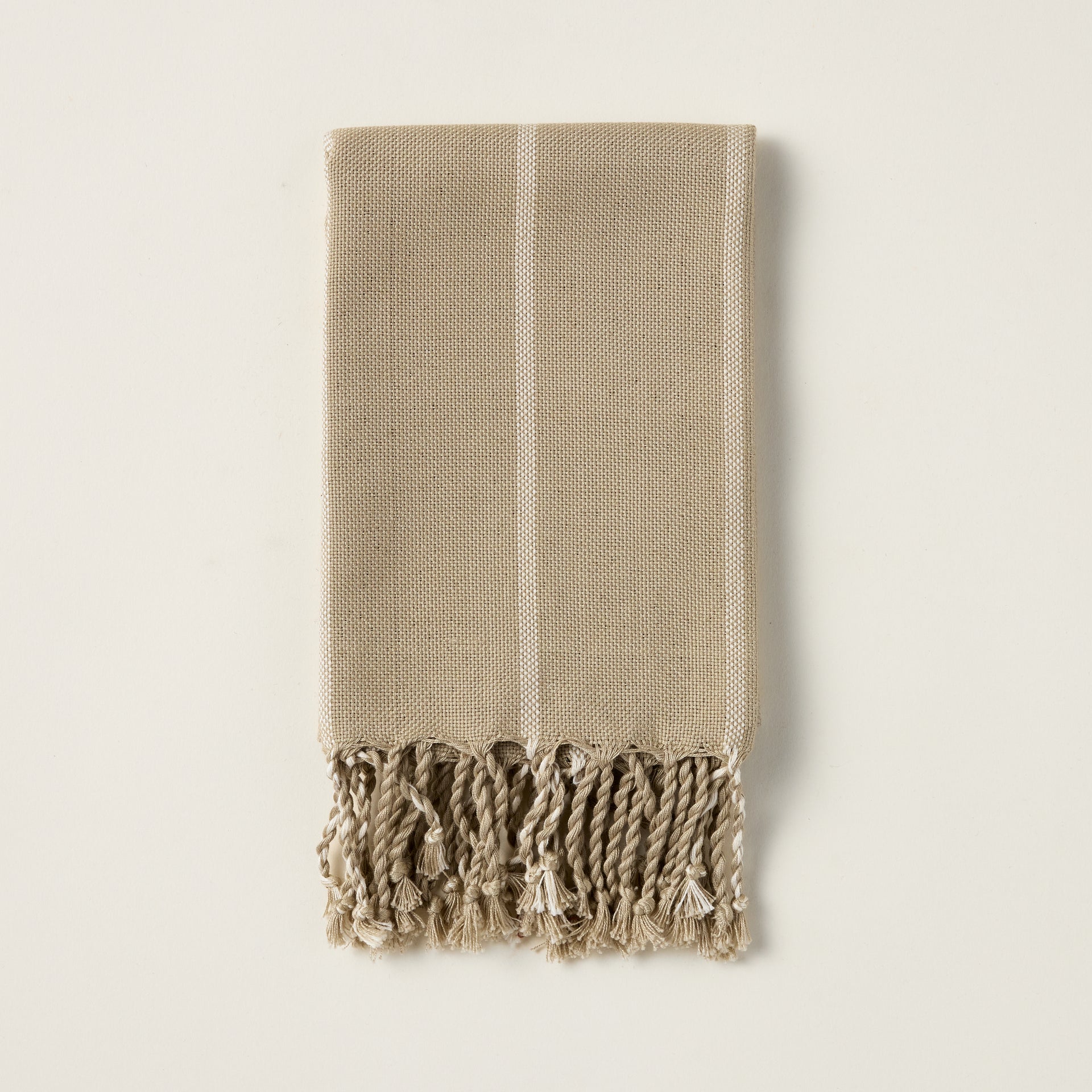June hand towel with a vertical striped pattern in yarn-dyed taupe and green, and a natural fringe.