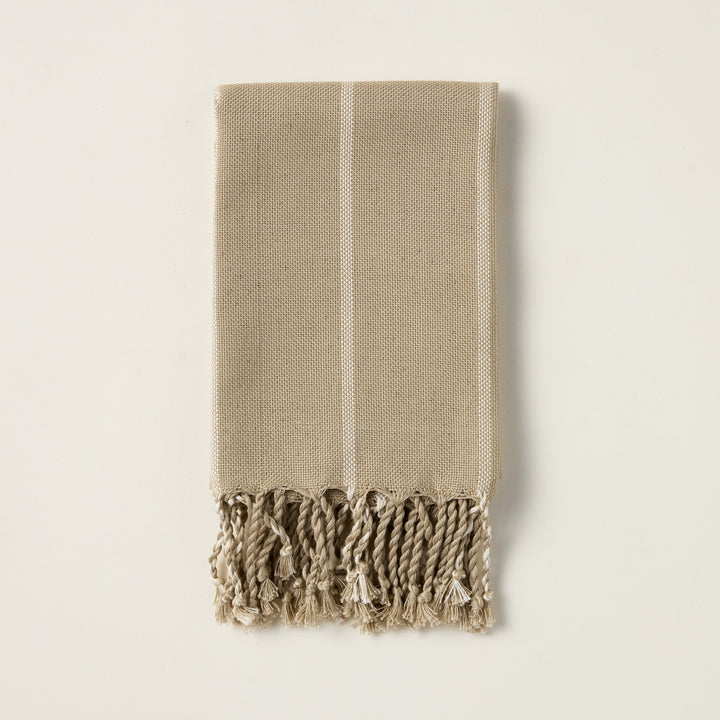 June hand towel with a vertical striped pattern in yarn-dyed taupe and green, and a natural fringe.