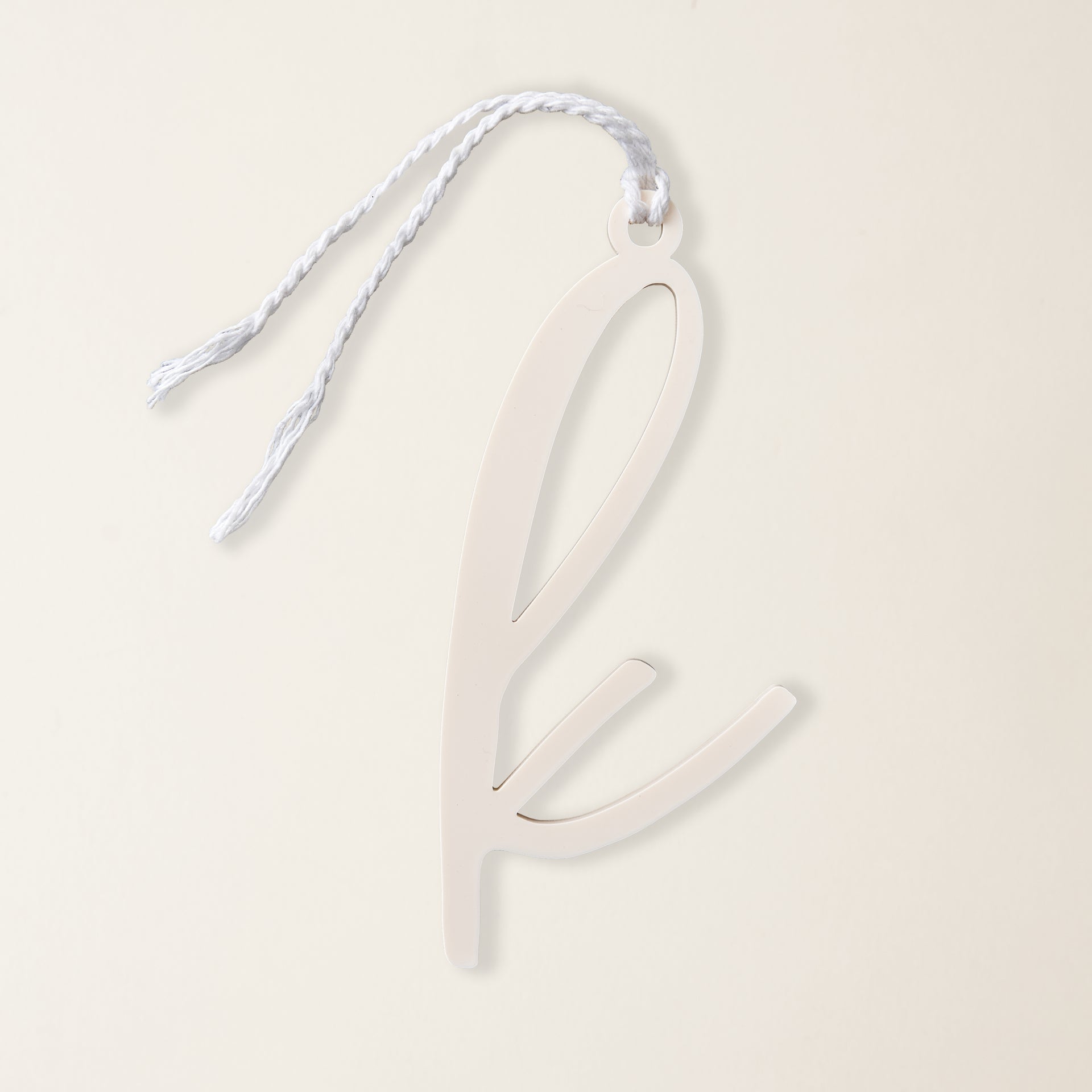 A clear acrylic Christmas ornament with a single monogram letter.
