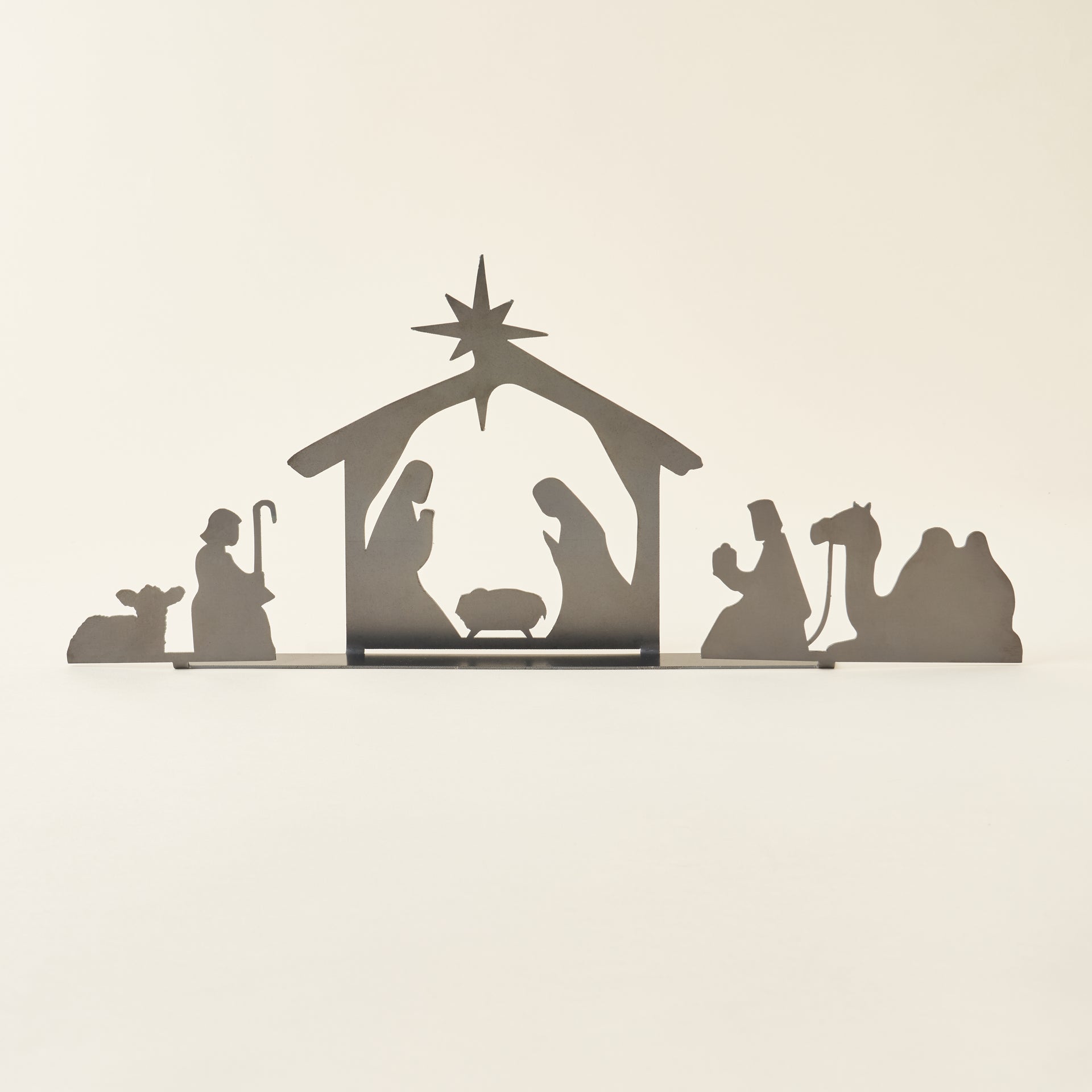 A decorative nativity set crafted from raw, untreated steel.