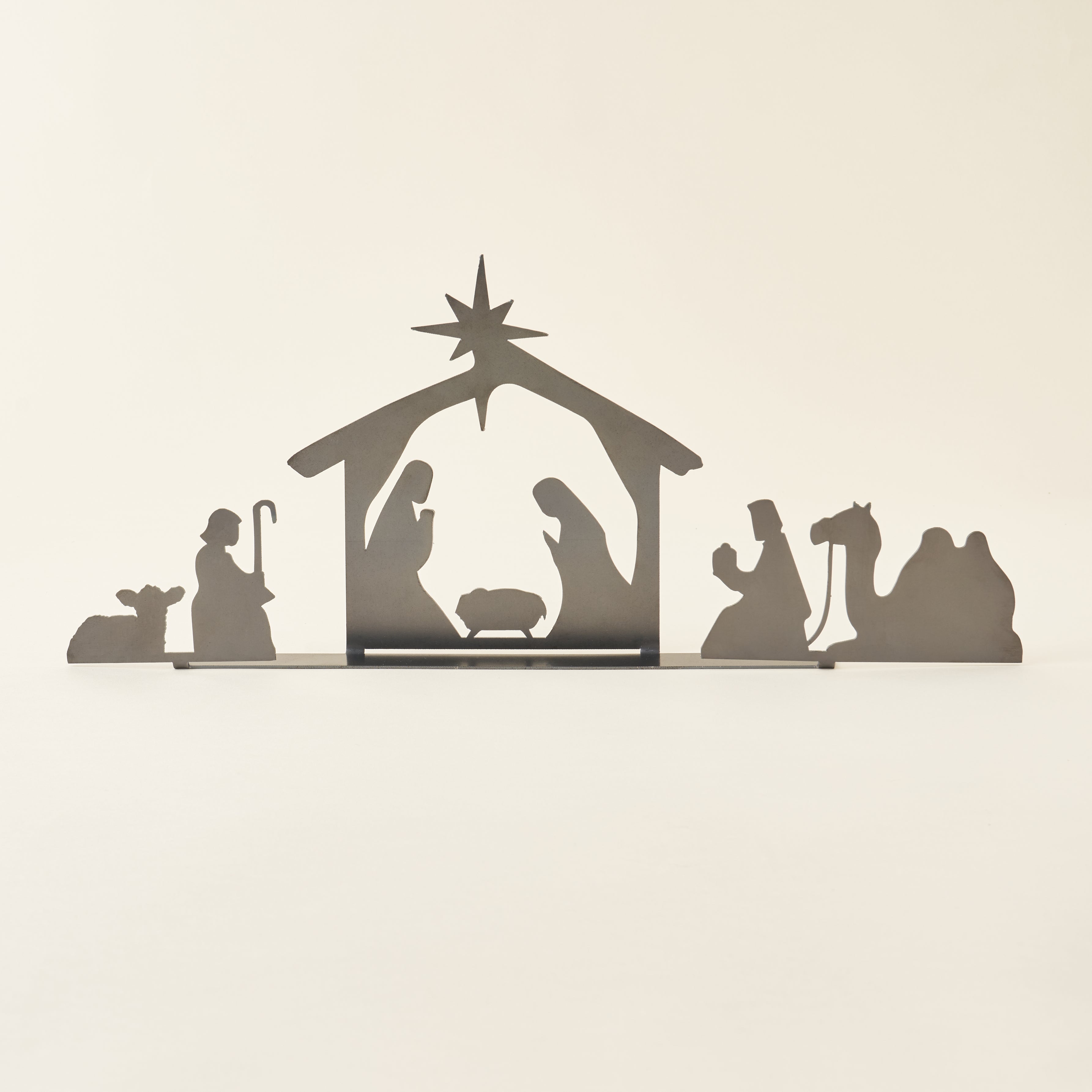 A decorative nativity set crafted from raw, untreated steel.