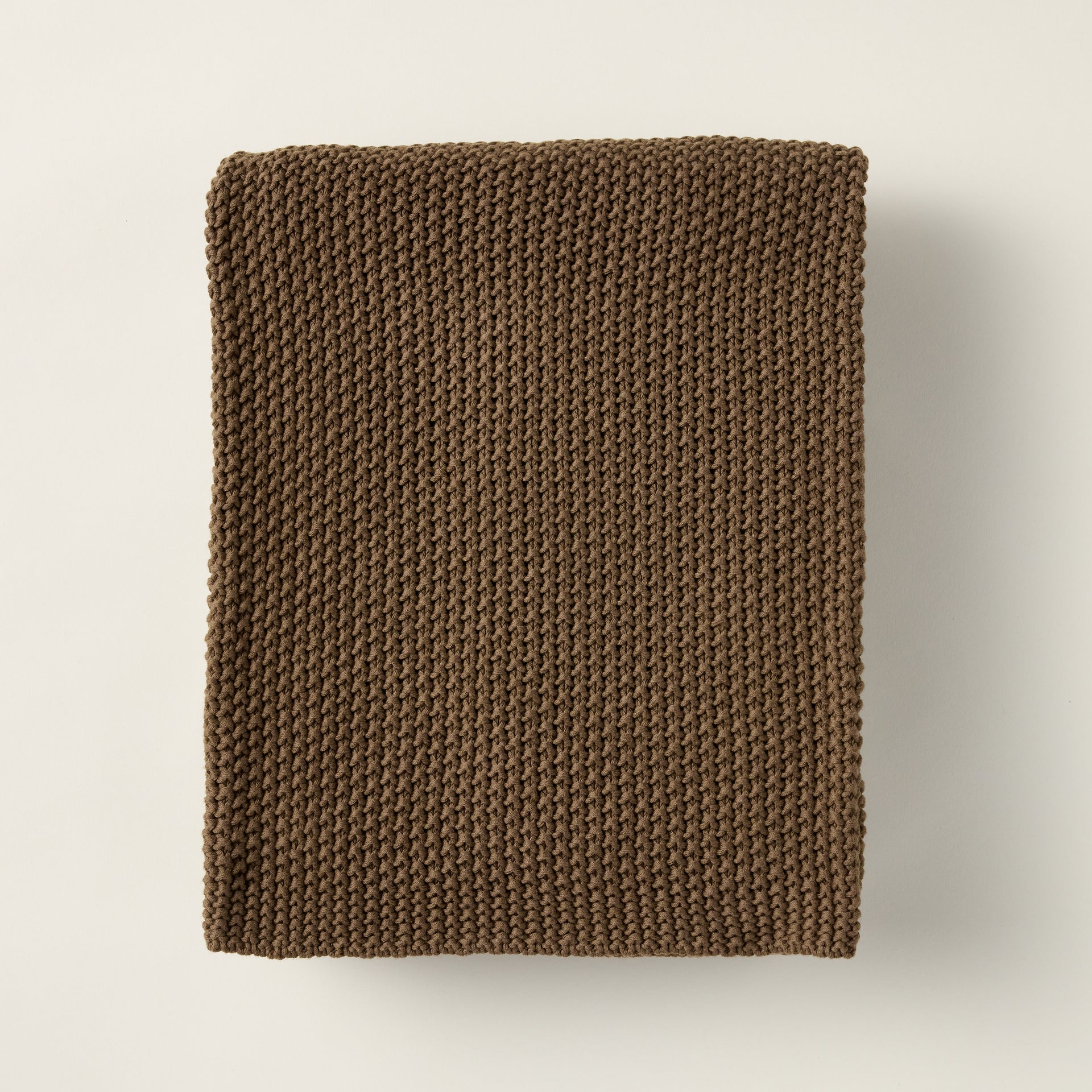 Nina throw blanket crafted from 100% woven cotton with a warm walnut color.