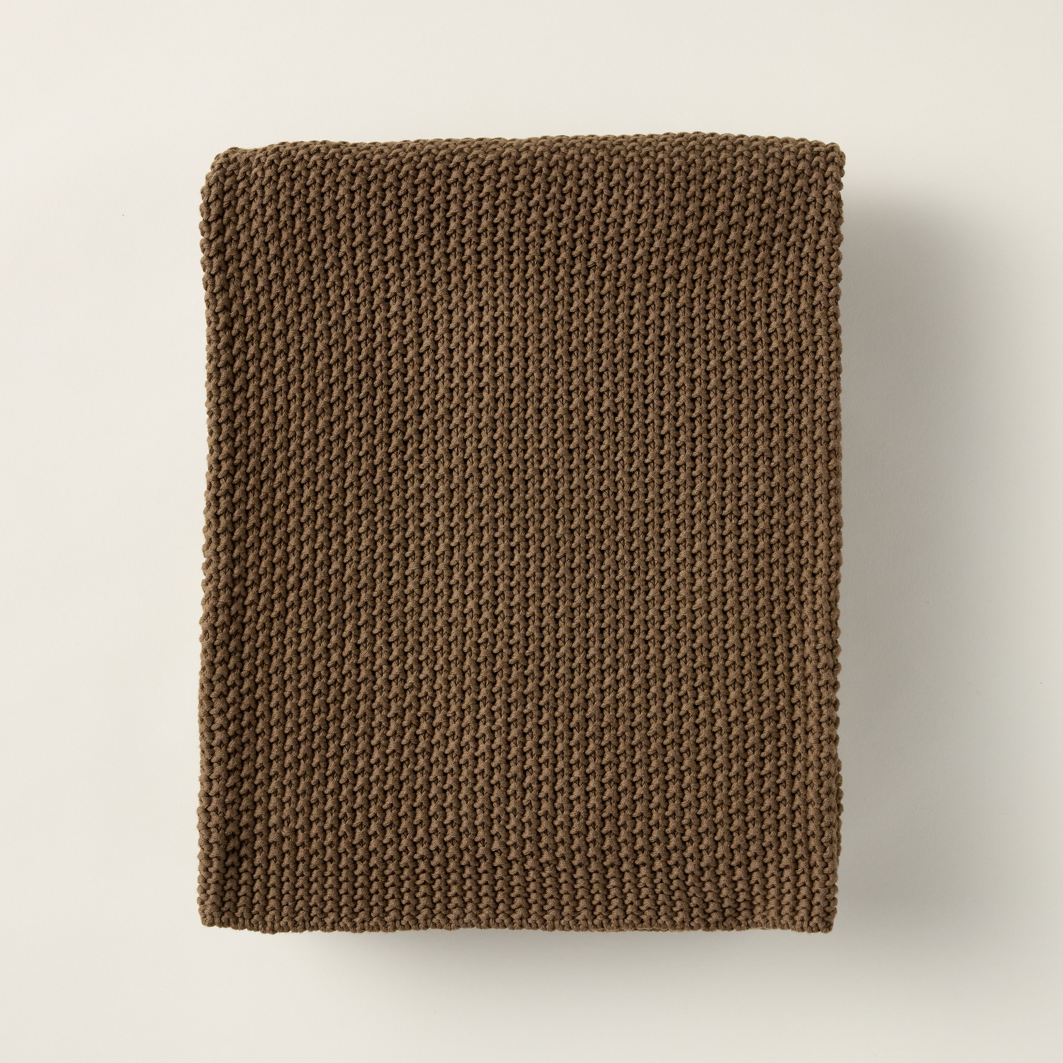 Nina throw blanket crafted from 100% woven cotton with a warm walnut color.