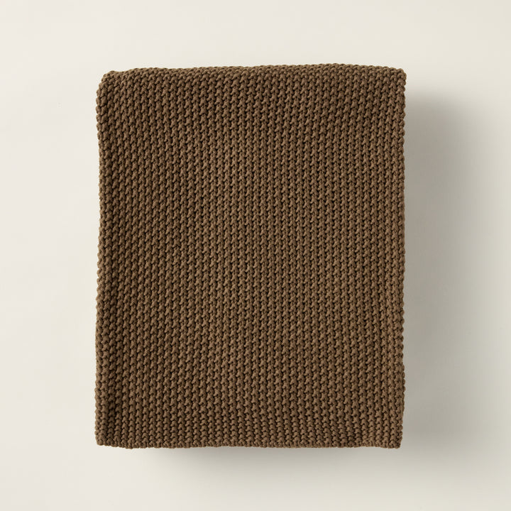Nina throw blanket crafted from 100% woven cotton with a warm walnut color.