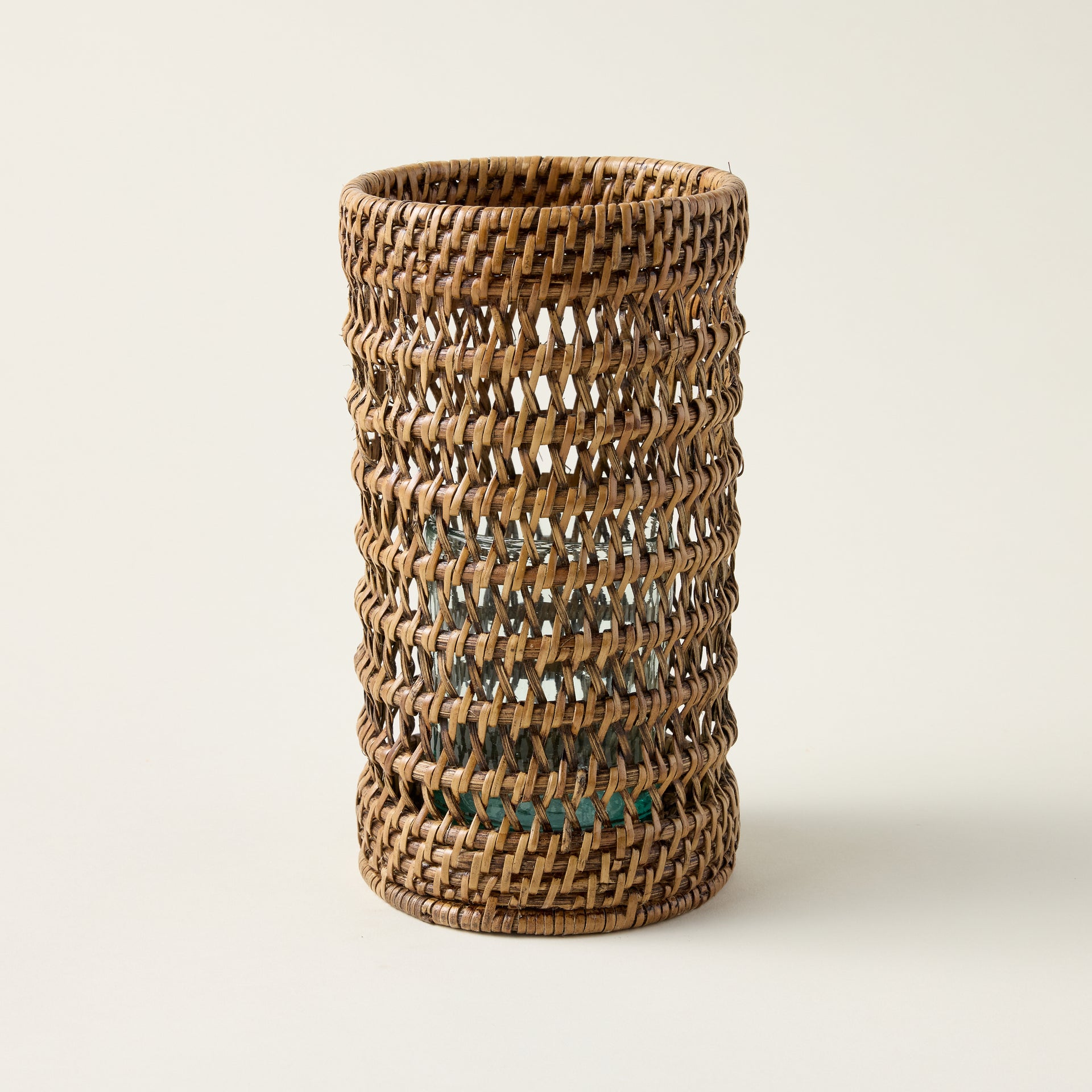 Handcrafted rattan hurricane lantern made from authentic Burma rattan, with a woven structure for soft light diffusion.