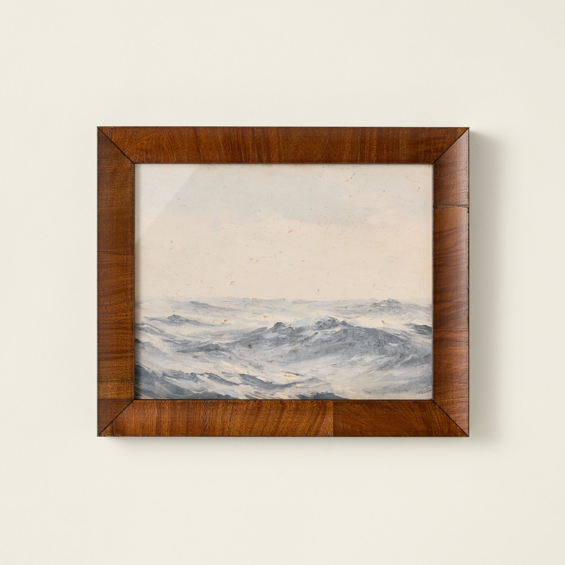 Vintage-inspired oil painting reproduction of ocean waves in a dark wooden frame.