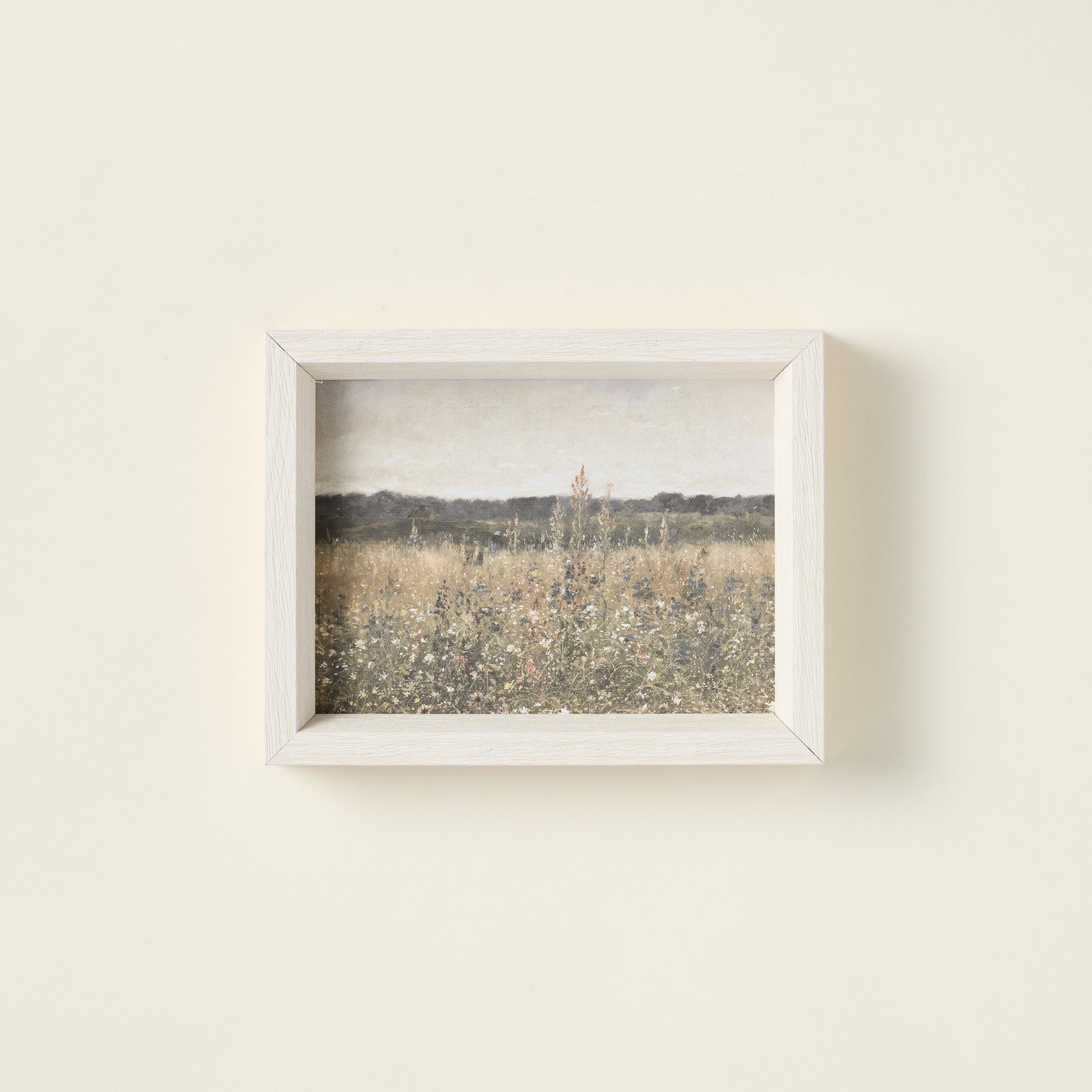 Framed art print of a wildflower field on raw canvas with an antique-style frame.